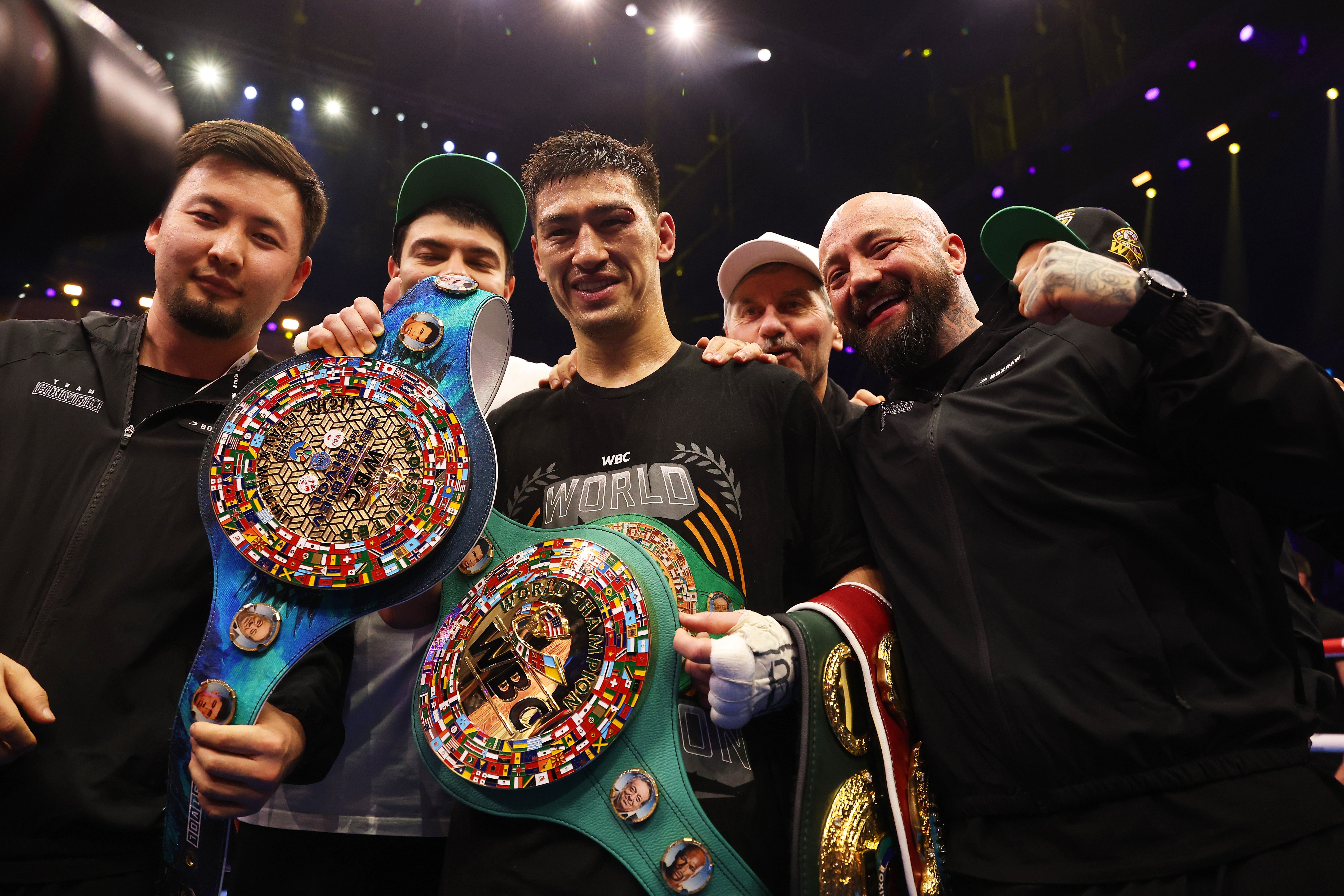 Dmitry Bivol and his team celebrate their undisputed title win