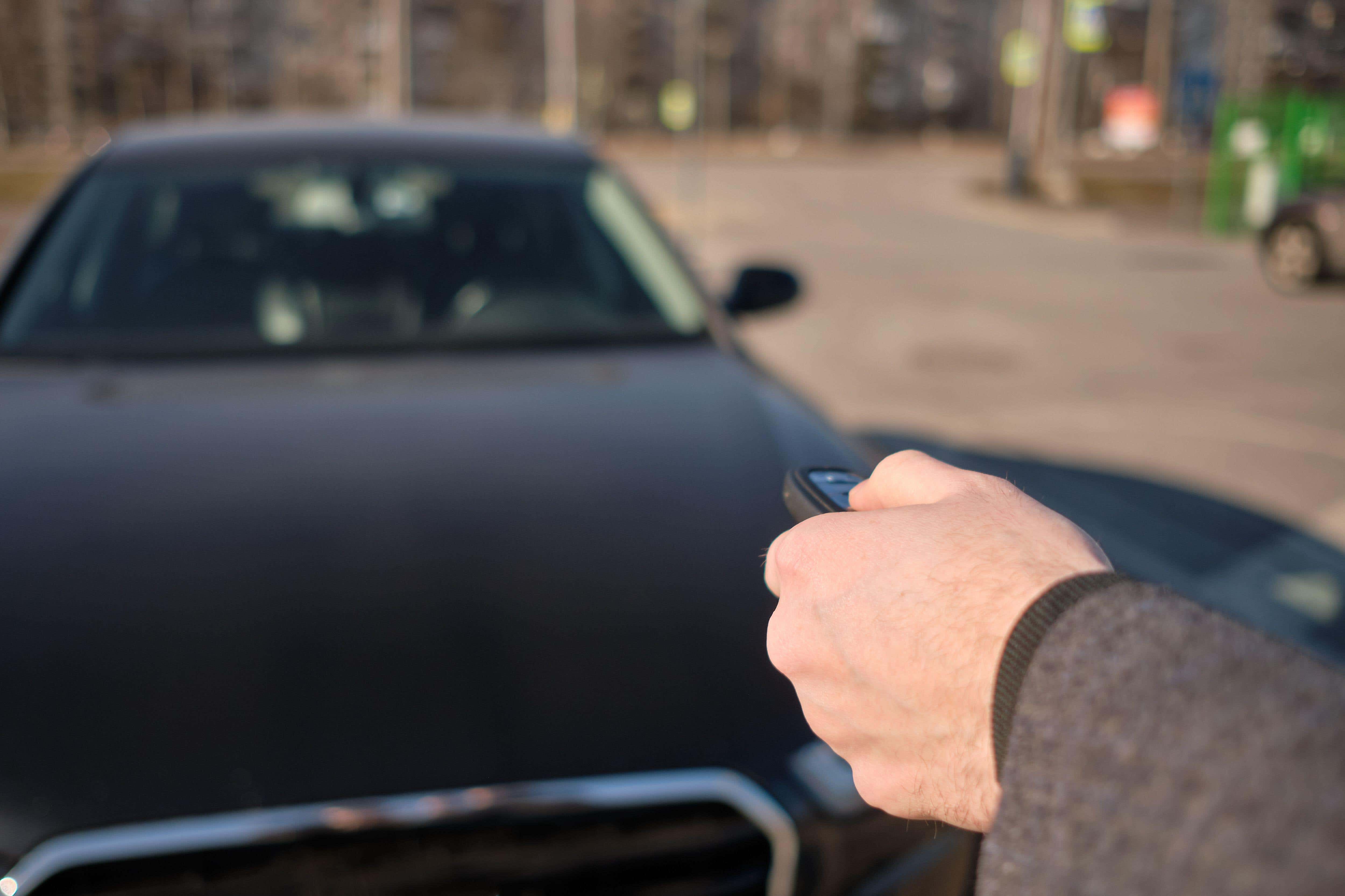 A man uses a remote key fob to open his car (Alamy/PA)