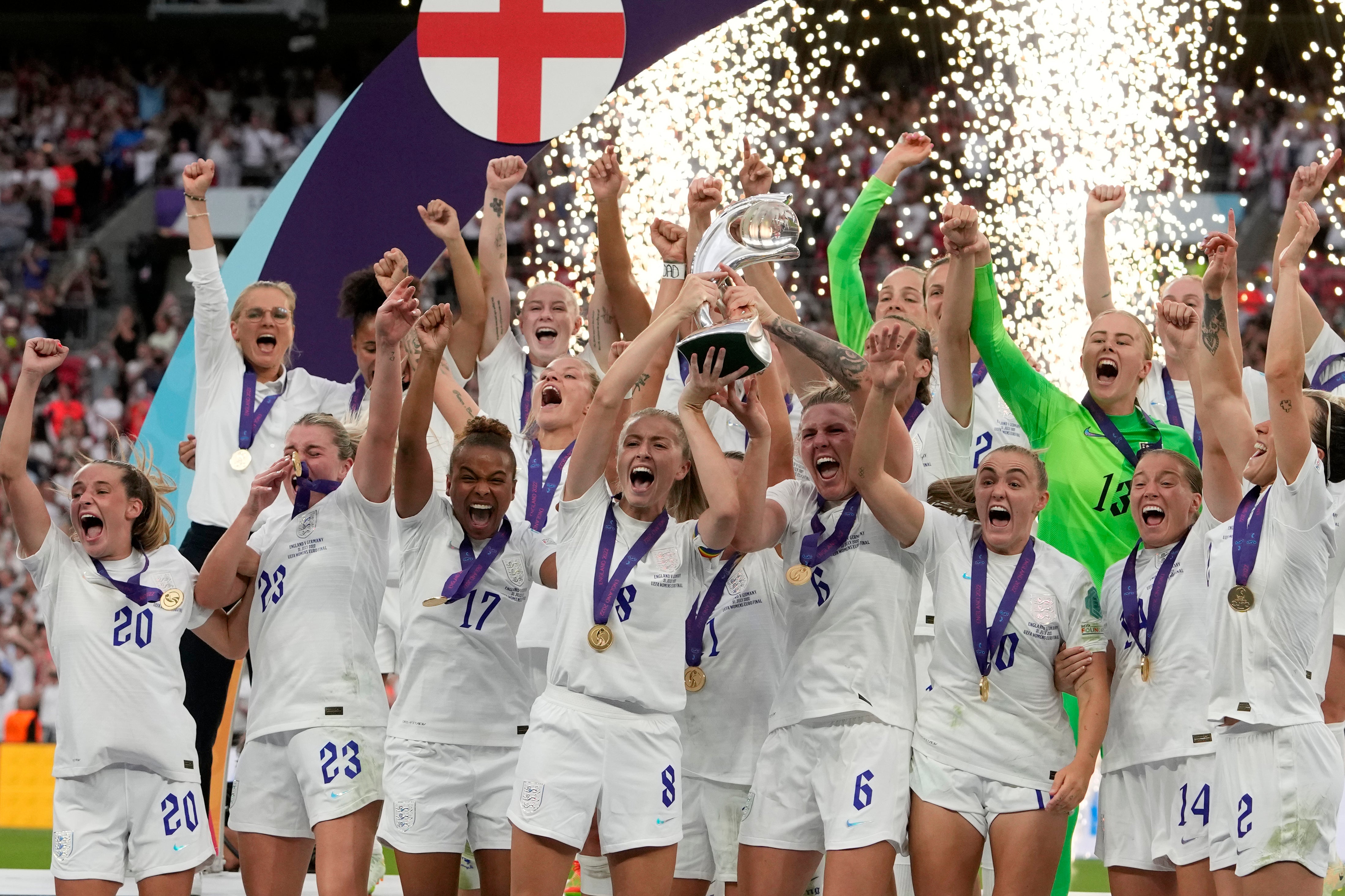 The Lionesses captain (centre left) lifts the trophy with her teammate Millie Bright after winning the Women's Euro 2022 final