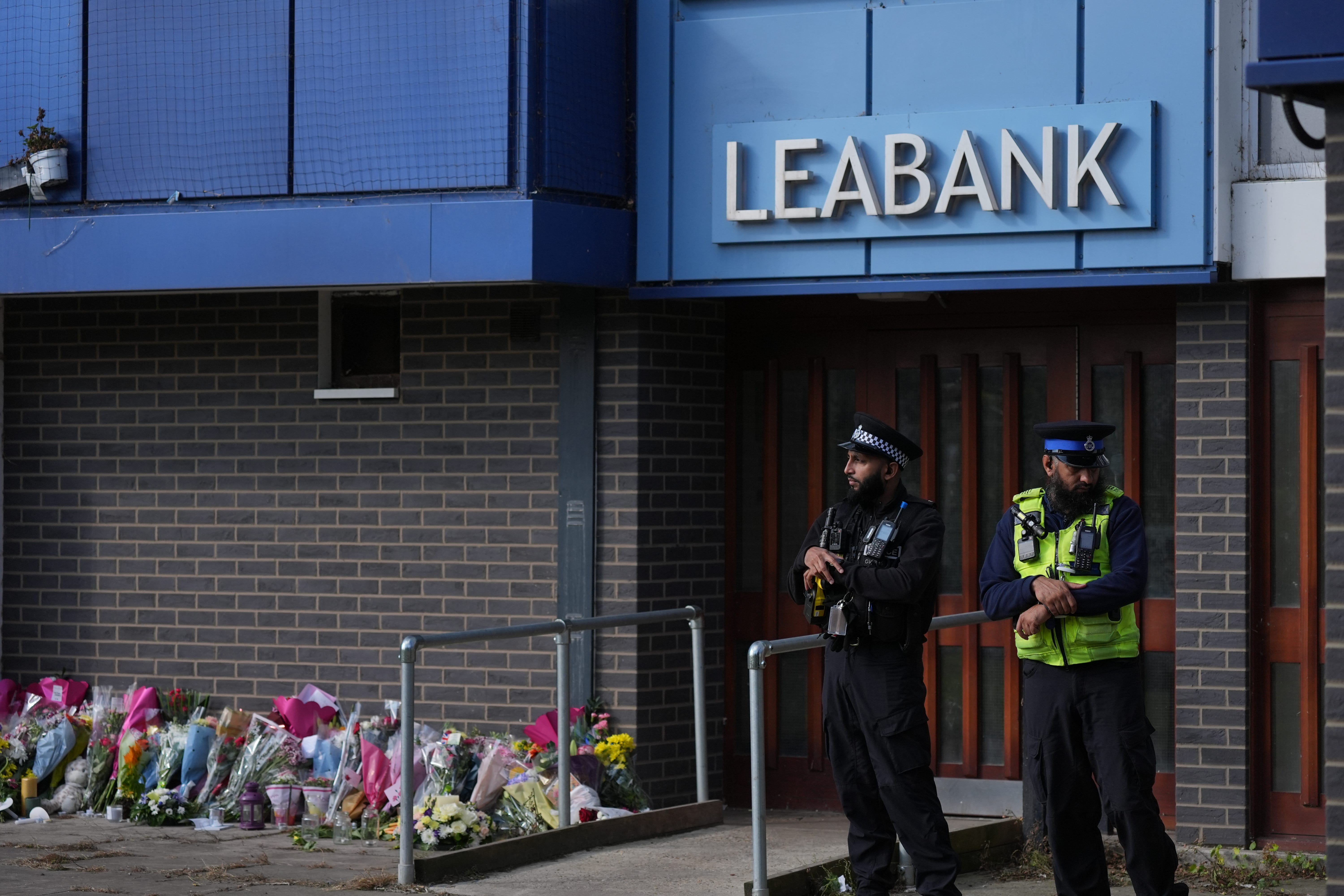 Police officers at Leabank in Luton, Bedfordshire where the family was killed (PA)
