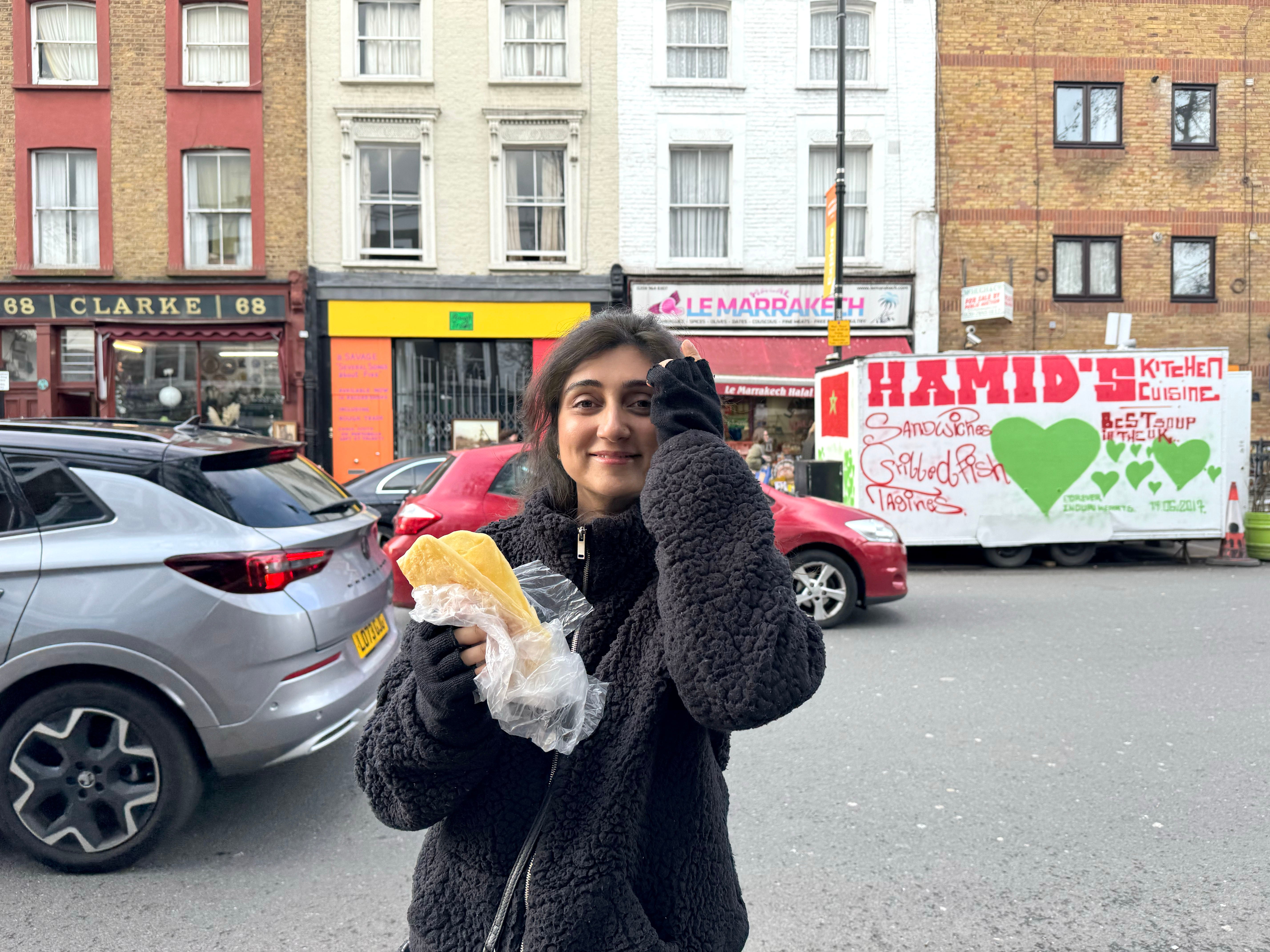 Queenie holding her rghaif outside Le Marrakech