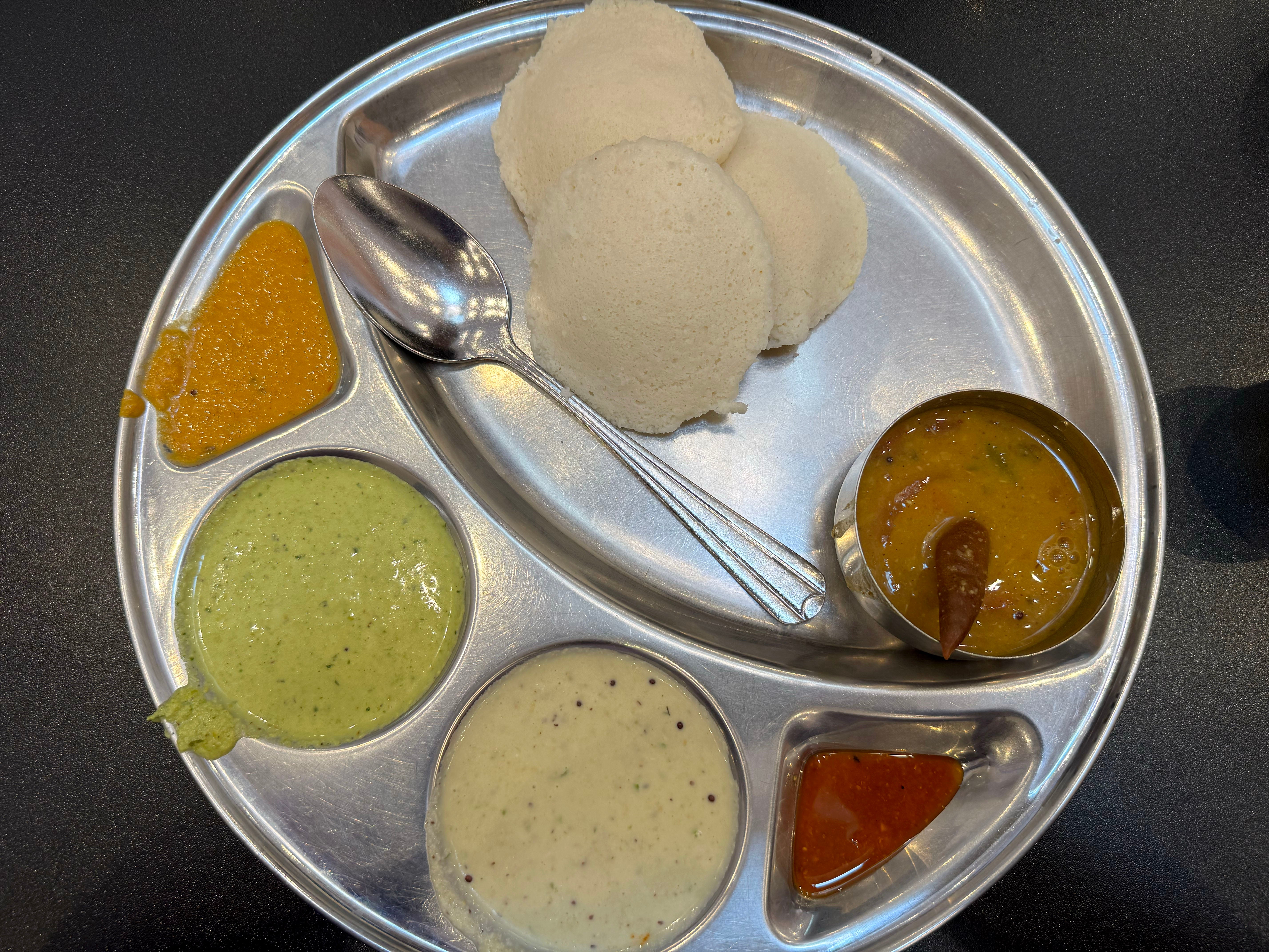 Idlis, soft, pillowy rice pancakes served with sambar, a lentil-vegetable stew