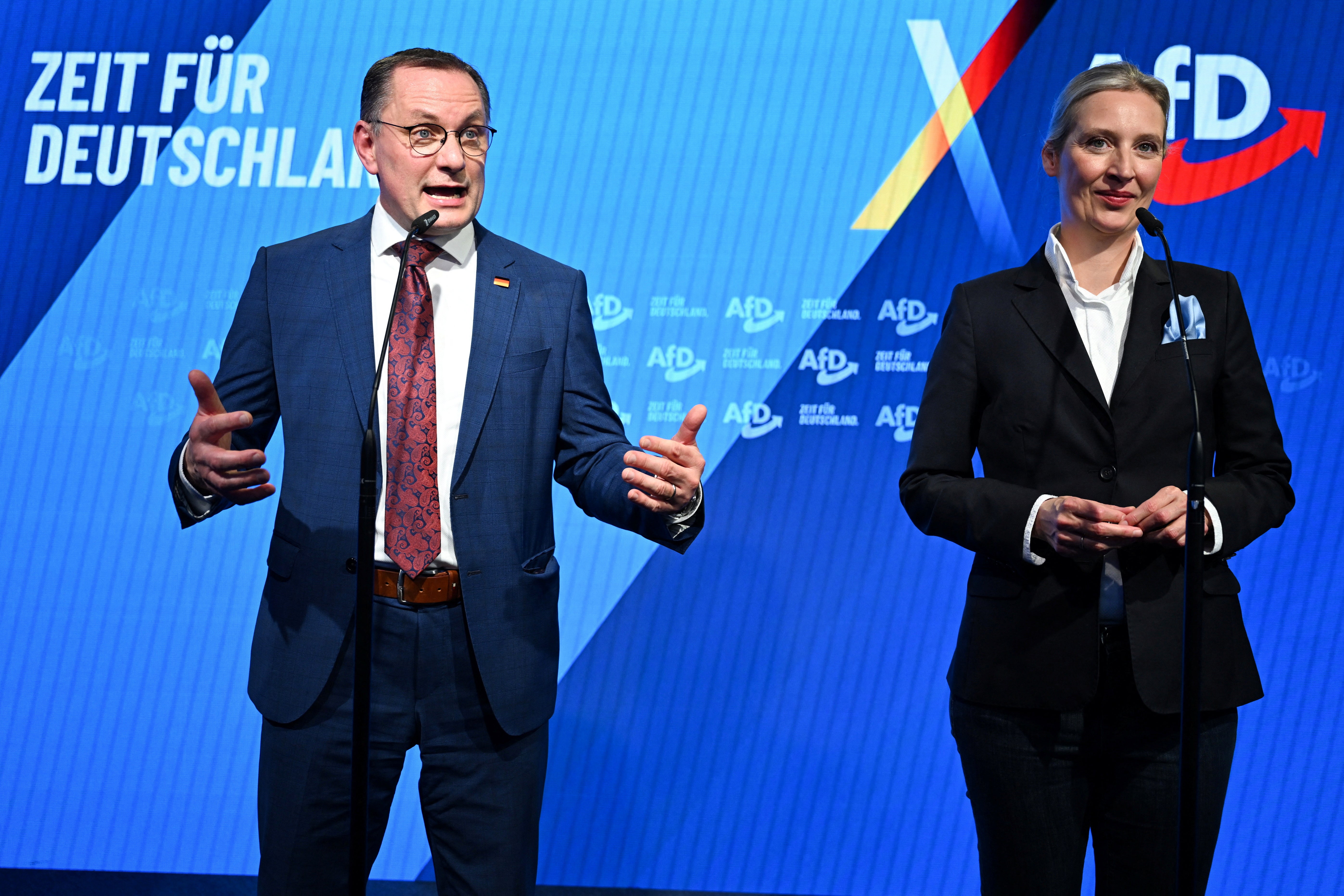 Alternative for Germany (AfD) party co-leaders Tino Chrupalla and Alice Weidel react after first exit polls