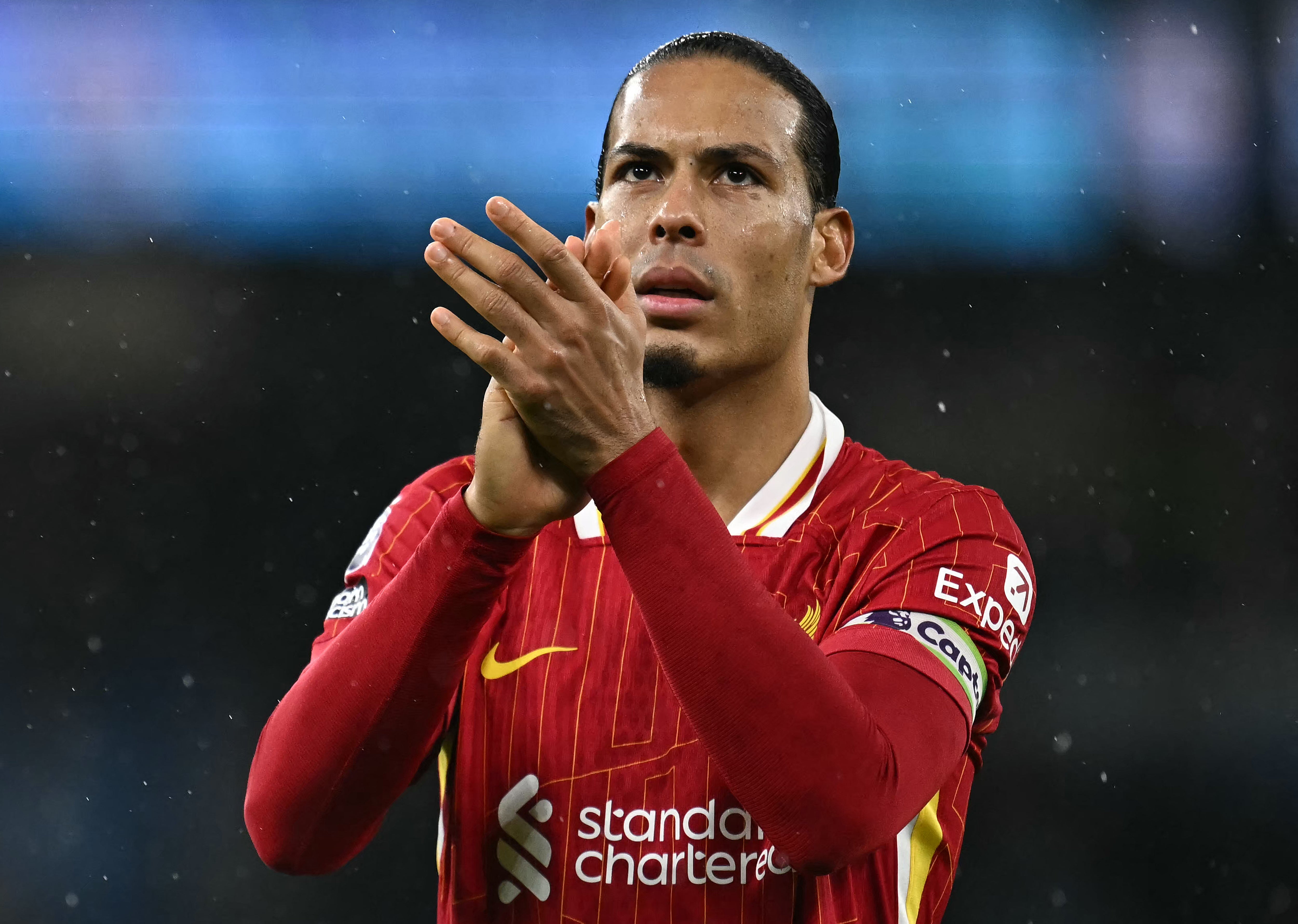 <p>Virgil van Dijk applauds the Liverpool fans</p>