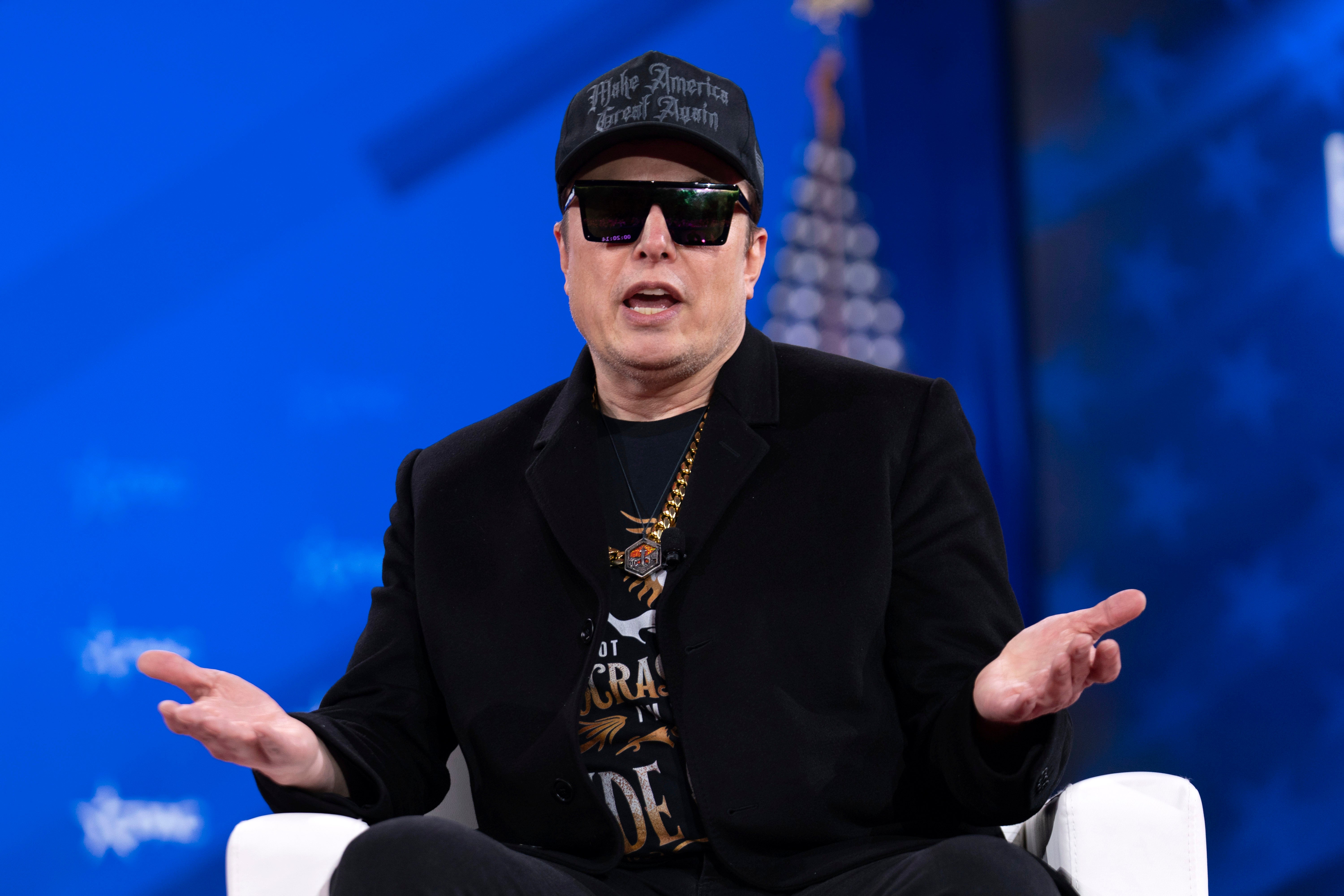 Elon Musk appears at the Conservative Political Action Conference after wielding a bejeweled chainsaw on stage.