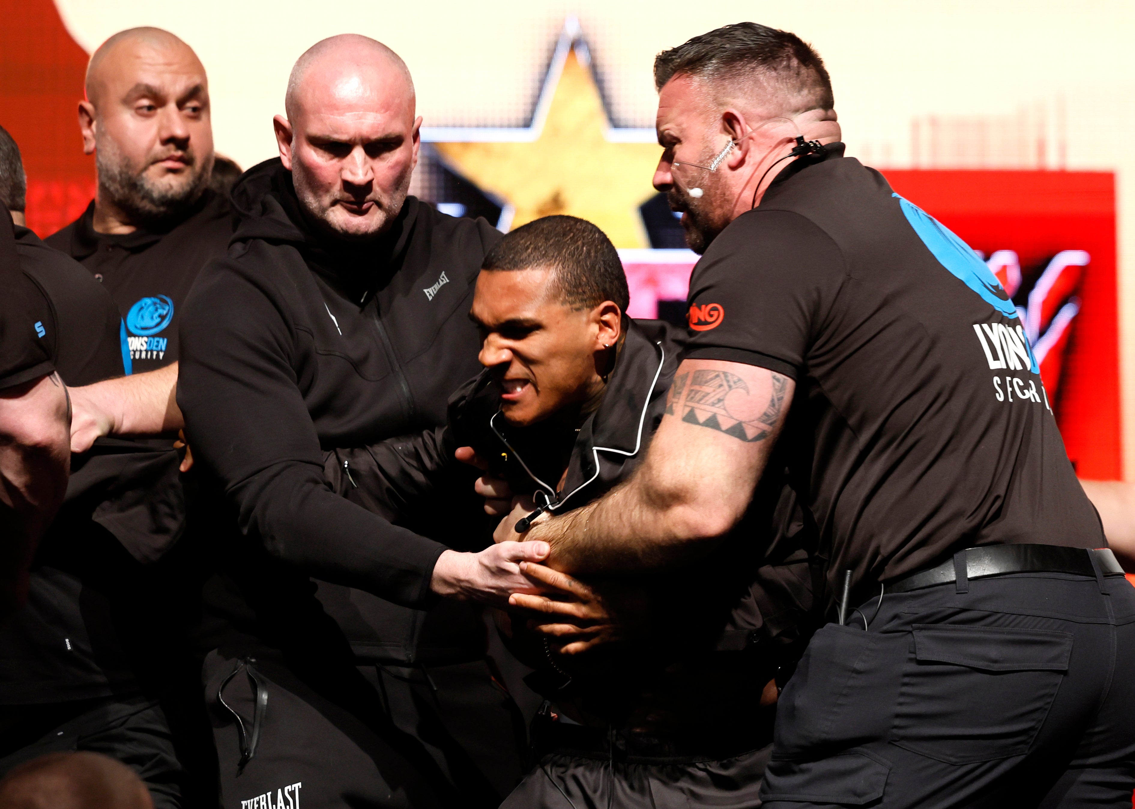 Things got ugly as Benn was held back by security