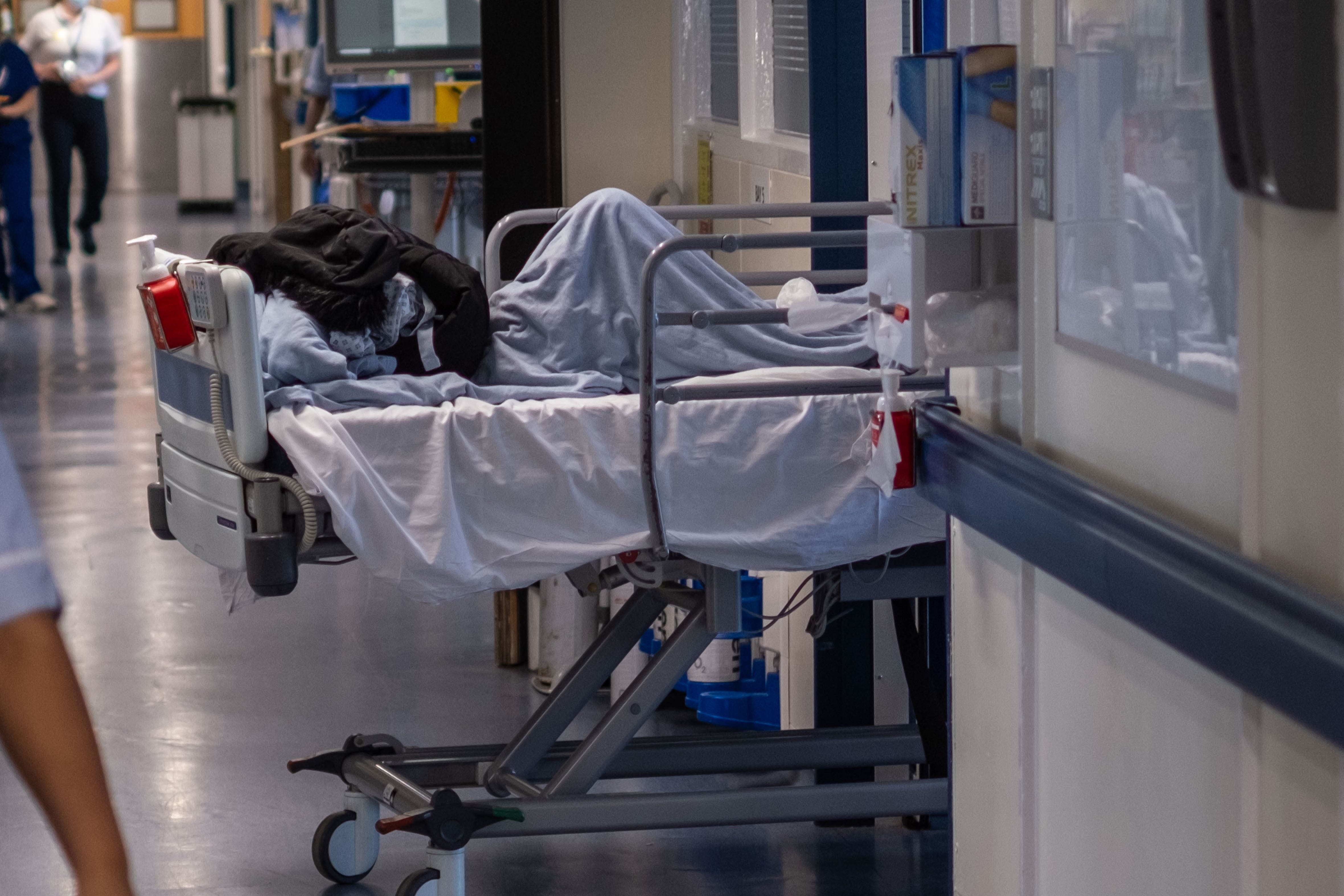 A patient bed on an NHS hospital ward in England (PA)