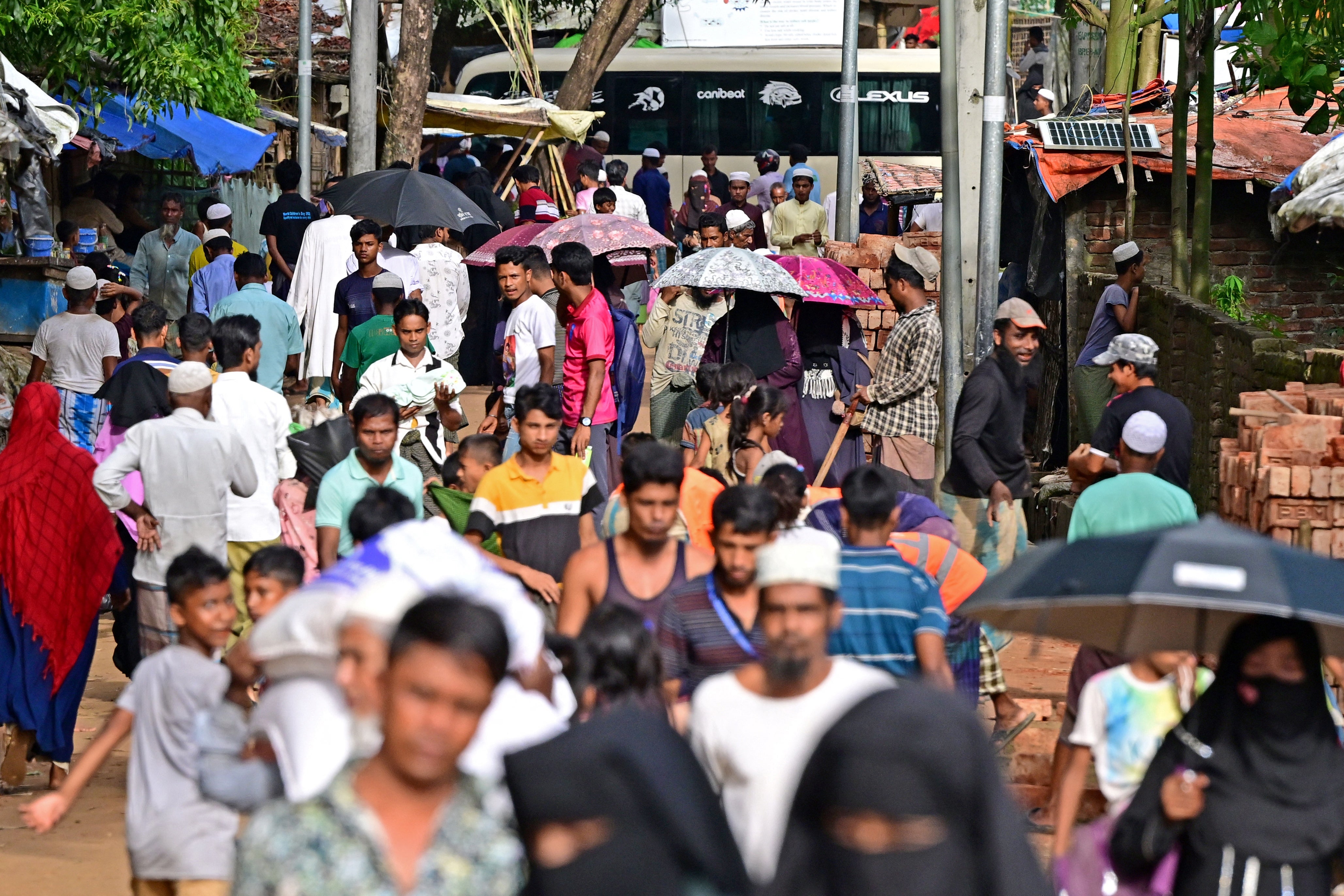 Rohingya refugees walk through a camp in Ukhia. Around a million members of the stateless and persecuted Muslim minority live in a sprawling patchwork of Bangladeshi relief camps after fleeing violence in their homeland next door.