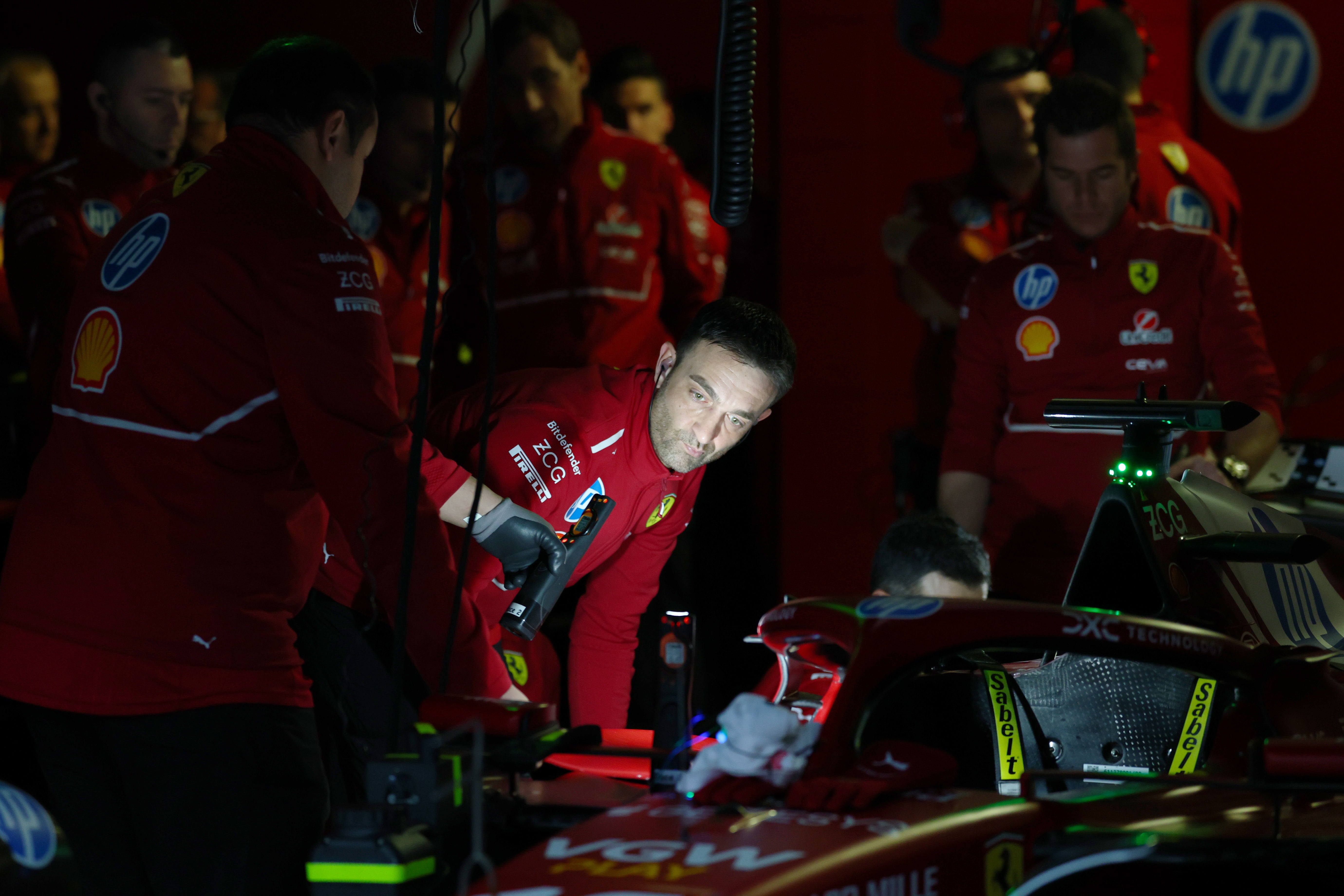 Ferrari mechanics use torches amid the power outage in Bahrain