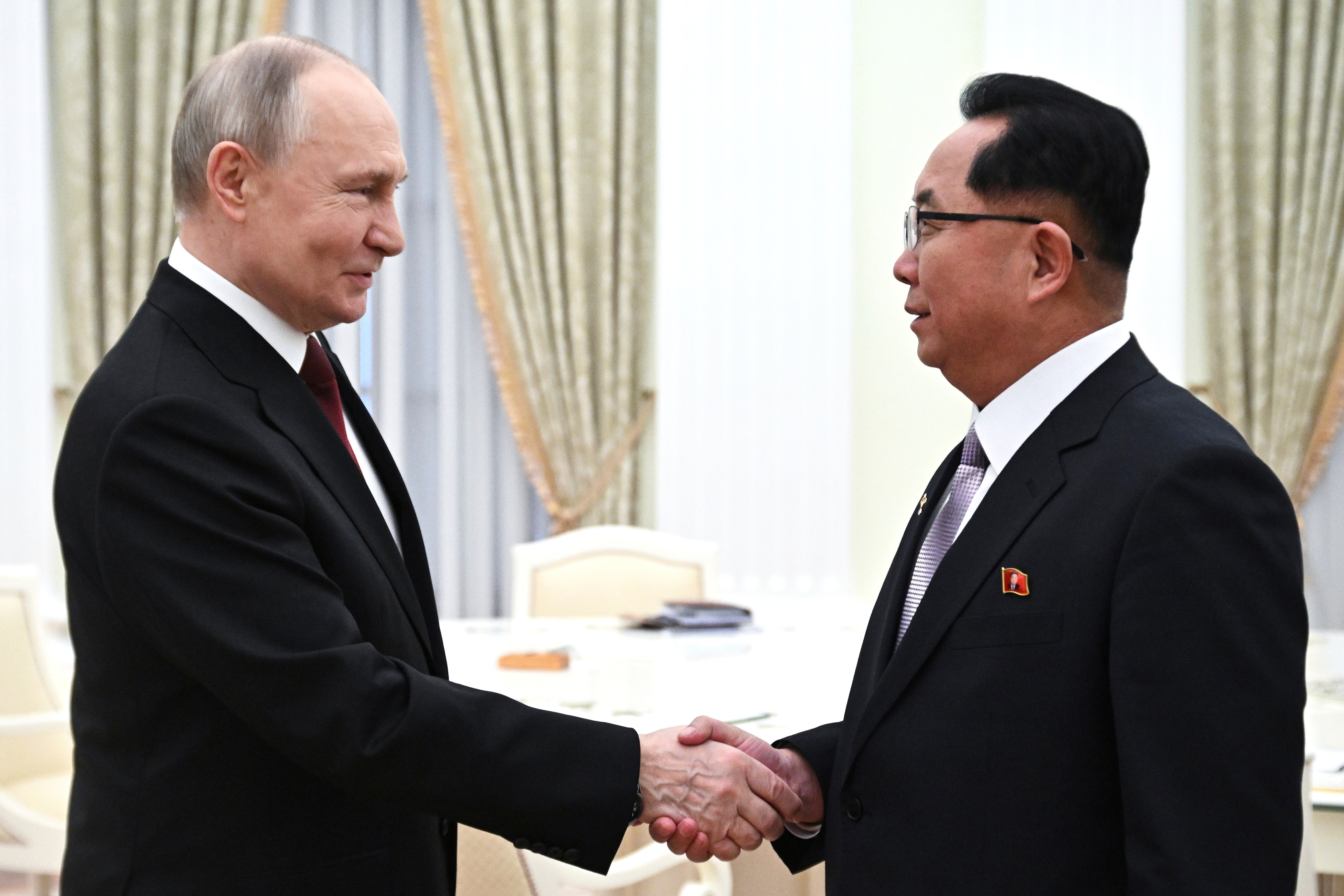 Russian President Vladimir Putin, left, and and member of the Politburo of the Central Committee of the Workers' Party of North Korea (WPK), Secretary of the WPK Central Committee Ri Hi-yong shake hands during their meeting at the Kremlin in Moscow, Russia, Thursday