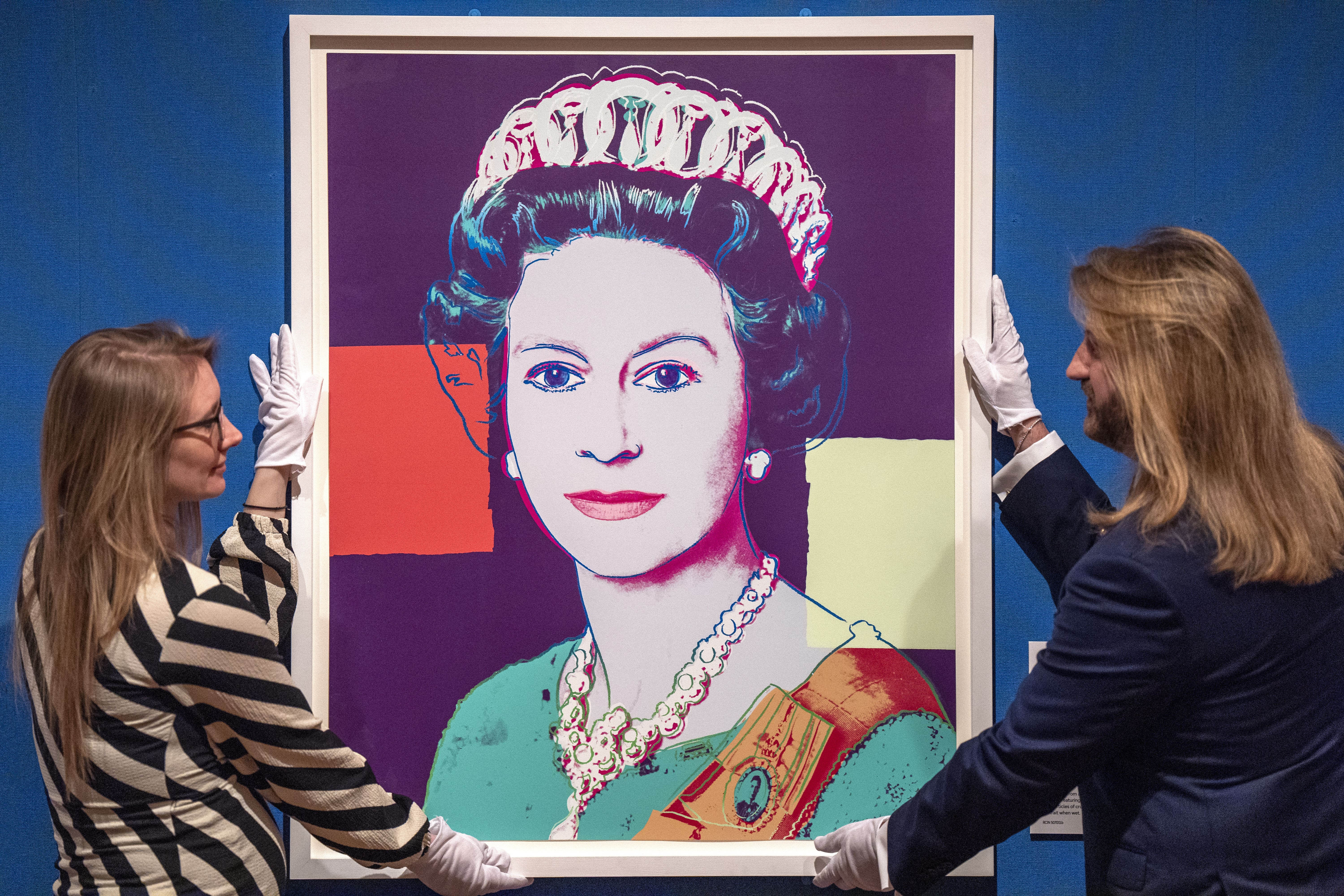 A screenprint portrait of Queen Elizabeth II by Andy Warhol (1985) is shown during a press view of Royal Portraits: A Century Of Photography (Jane Barlow/PA)