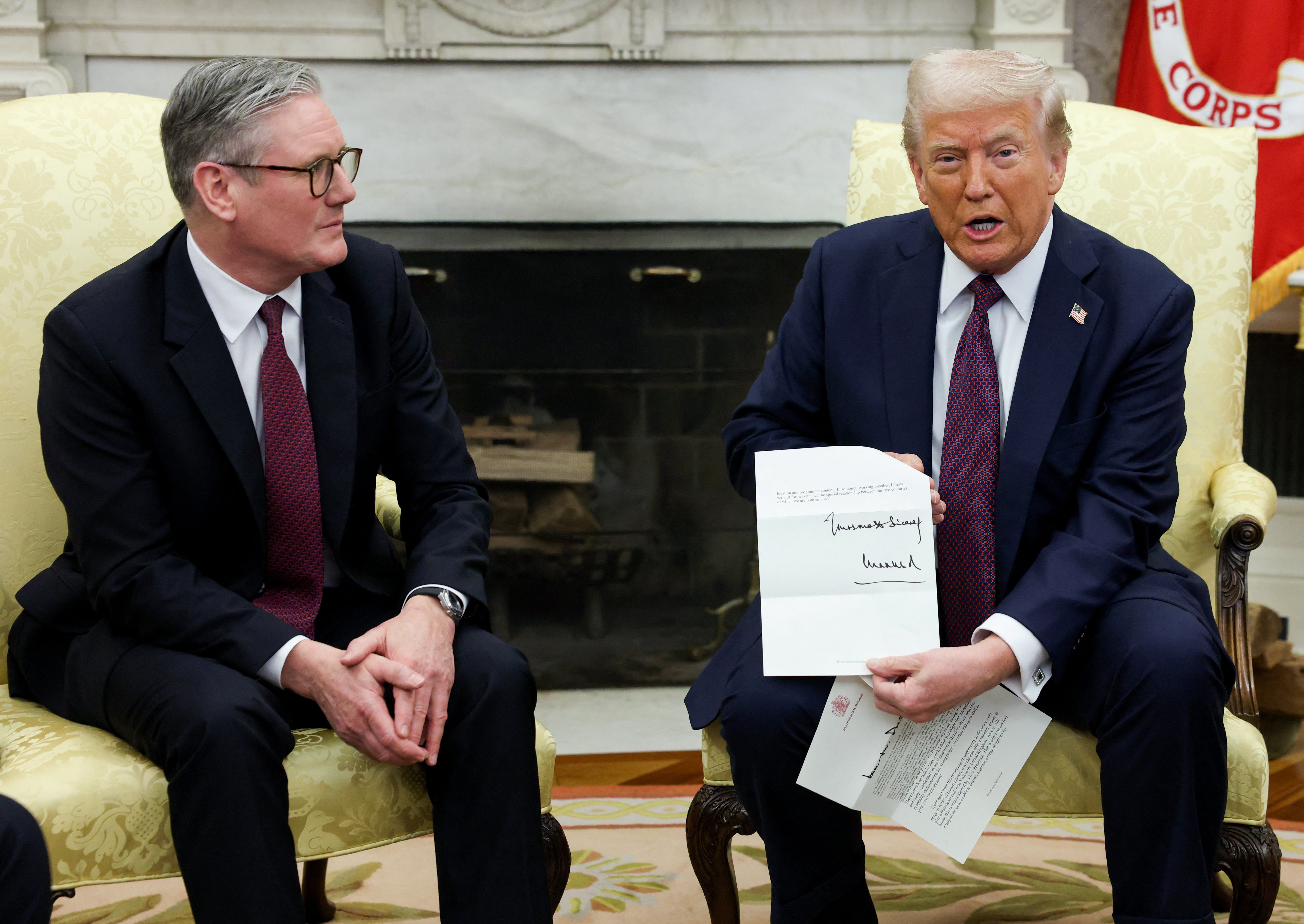 Trump holds a letter from King Charles as he meets with Keir Starmer in the Oval Office (REUTERS/Kevin Lamarque)