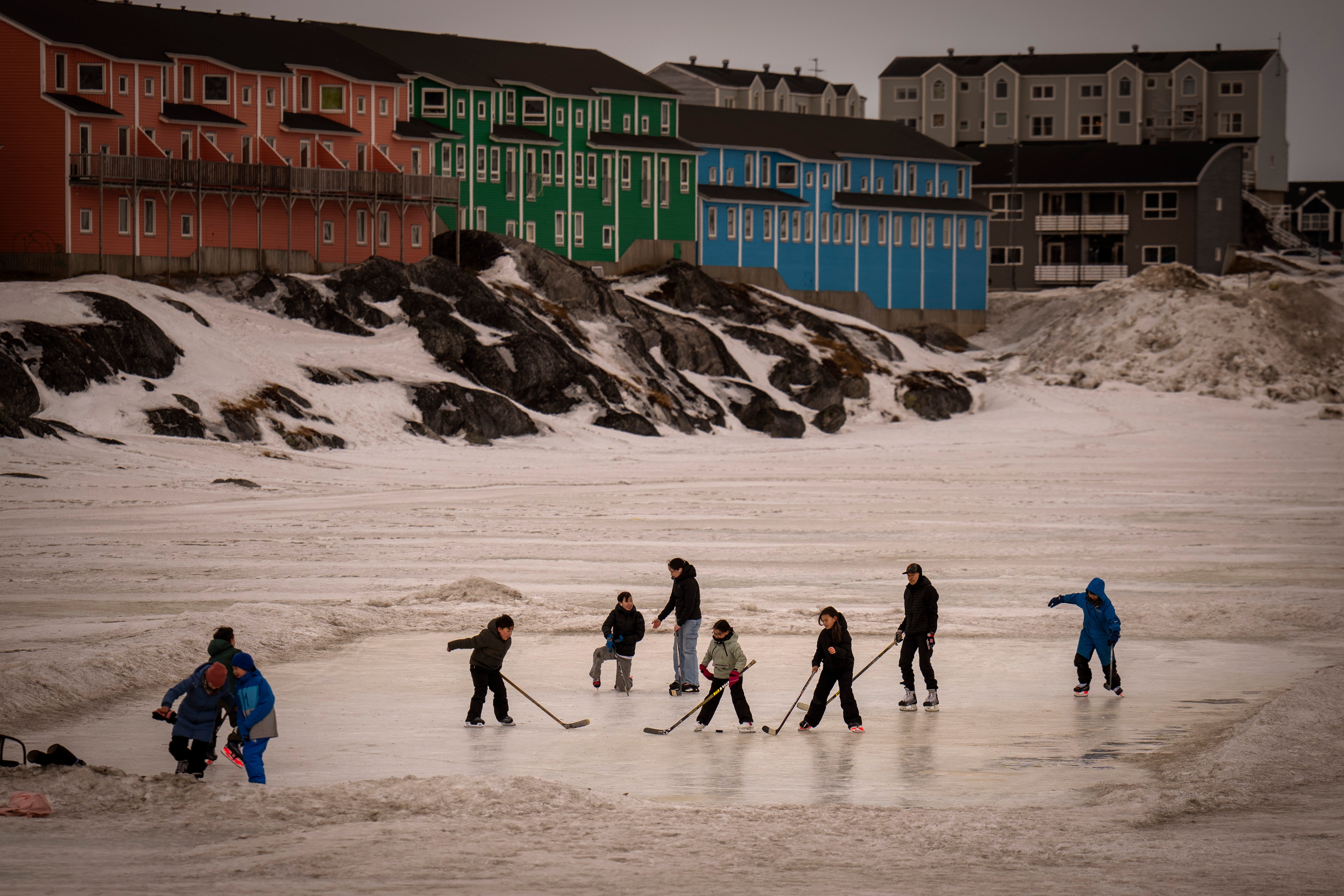 Children play on an icy surface in Nuuk