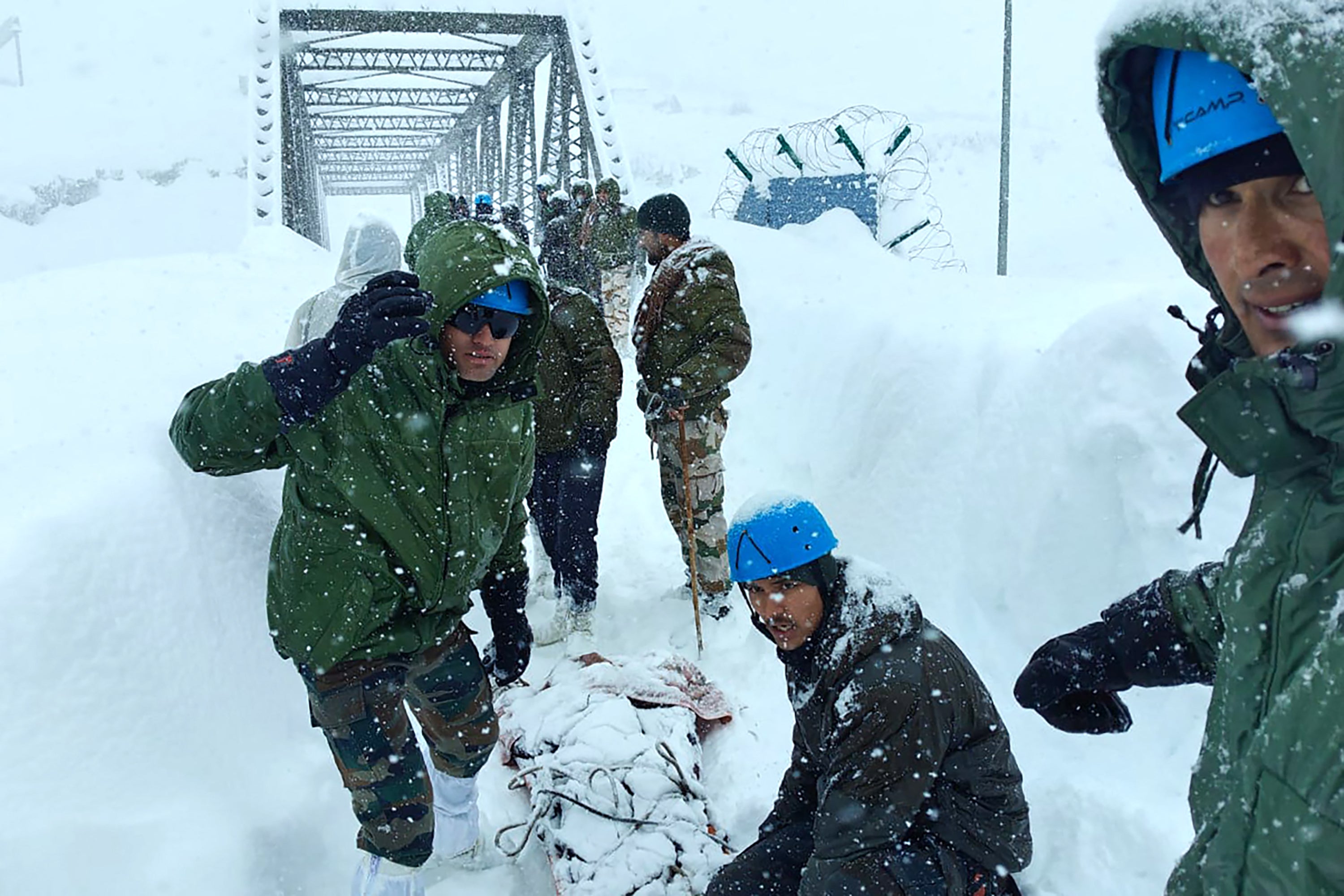 Rescuers carry out an operation after Border Roads Organisation workers were trapped under an avalanche near Mana village in Chamoli district of India's Uttarakhand state