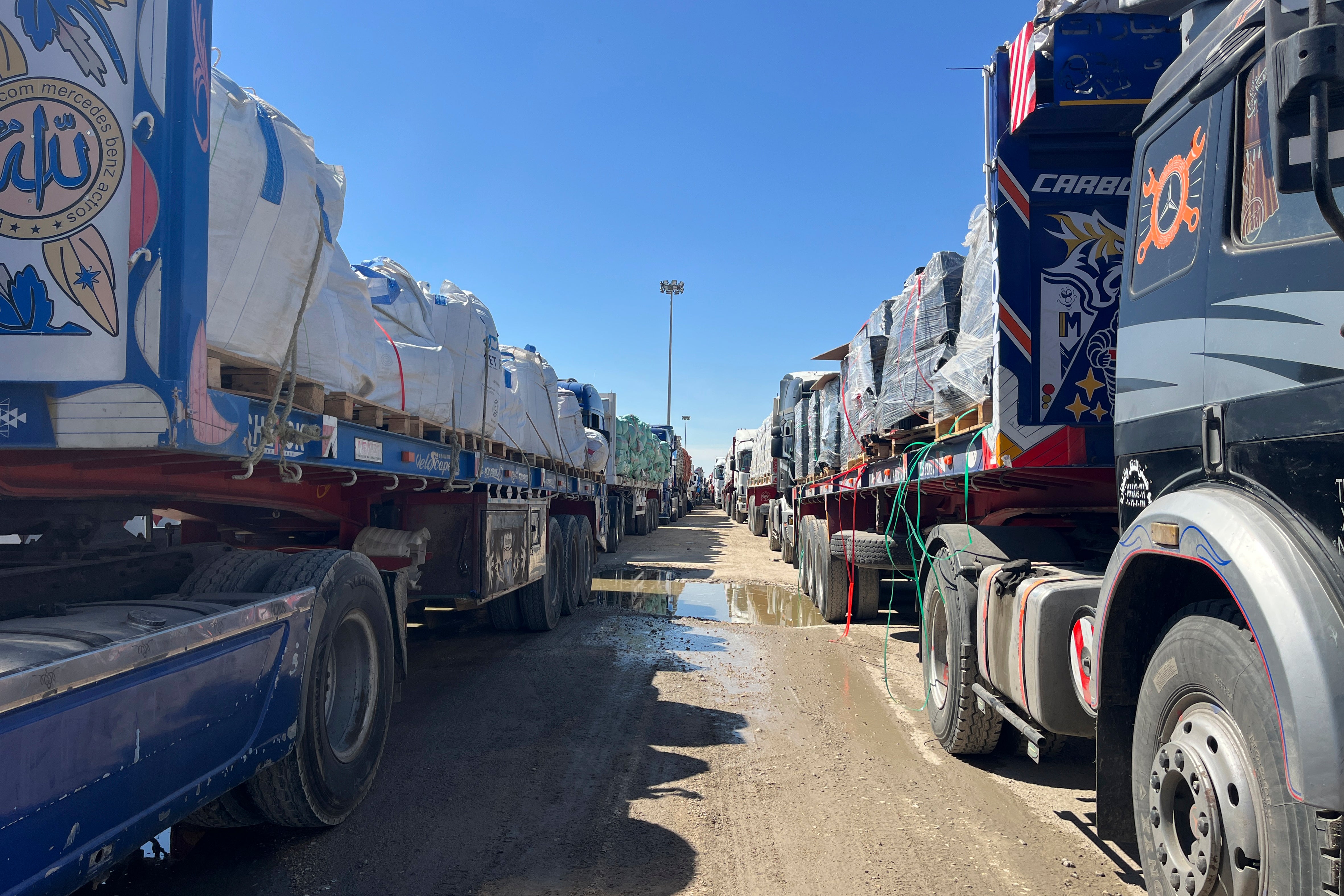 Trucks line up at the Egyptian side of the Rafah border crossing between Egypt and the Gaza Strip after Israel blocked the entry of aid trucks into Gaza (Mohamed Arafat/AP photo)