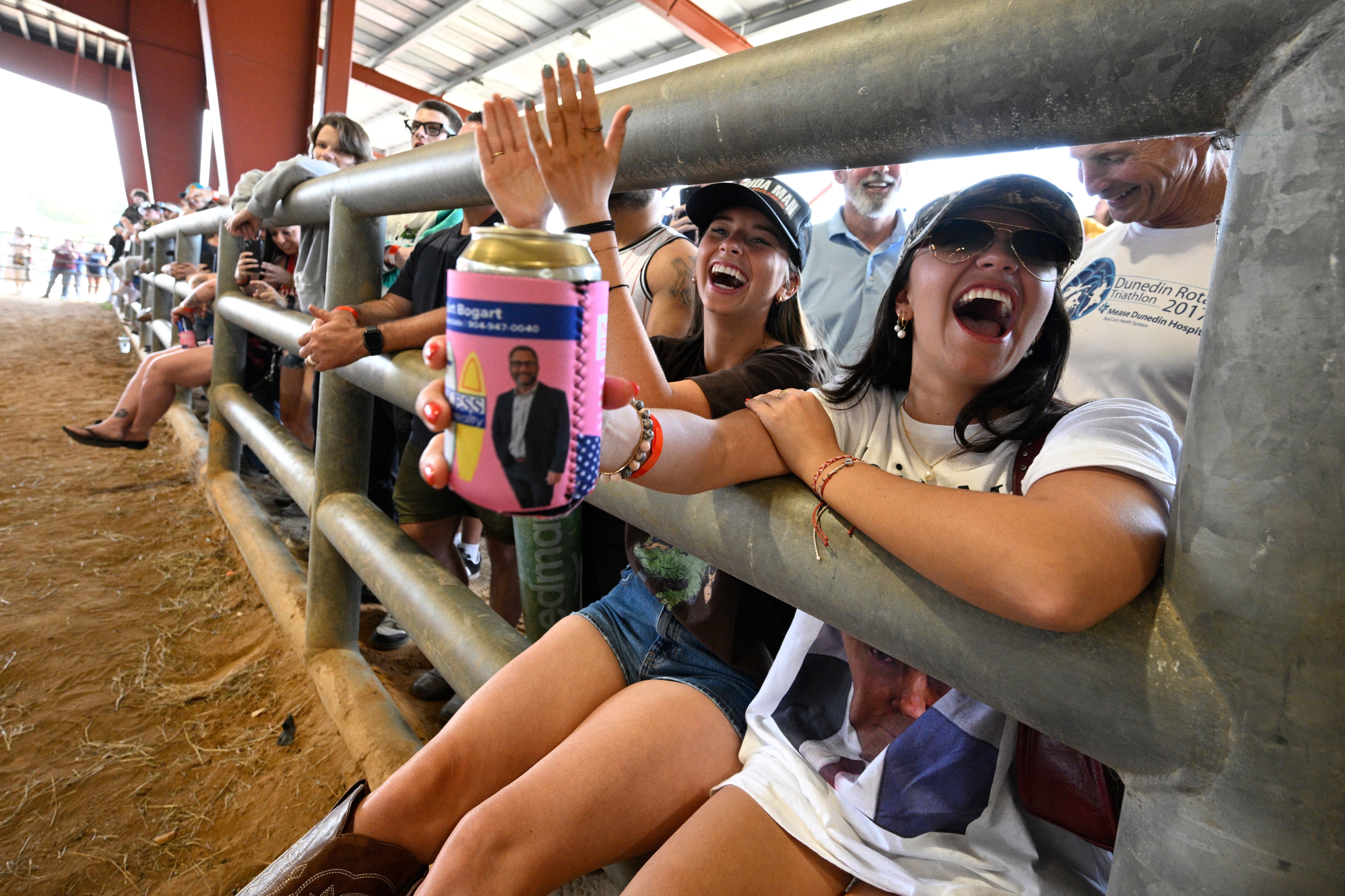 Natalia Kuppers, right, and Sophia Starkey, second from right, of Boca Raton, Florida, watch the Florida Man Games on Saturday
