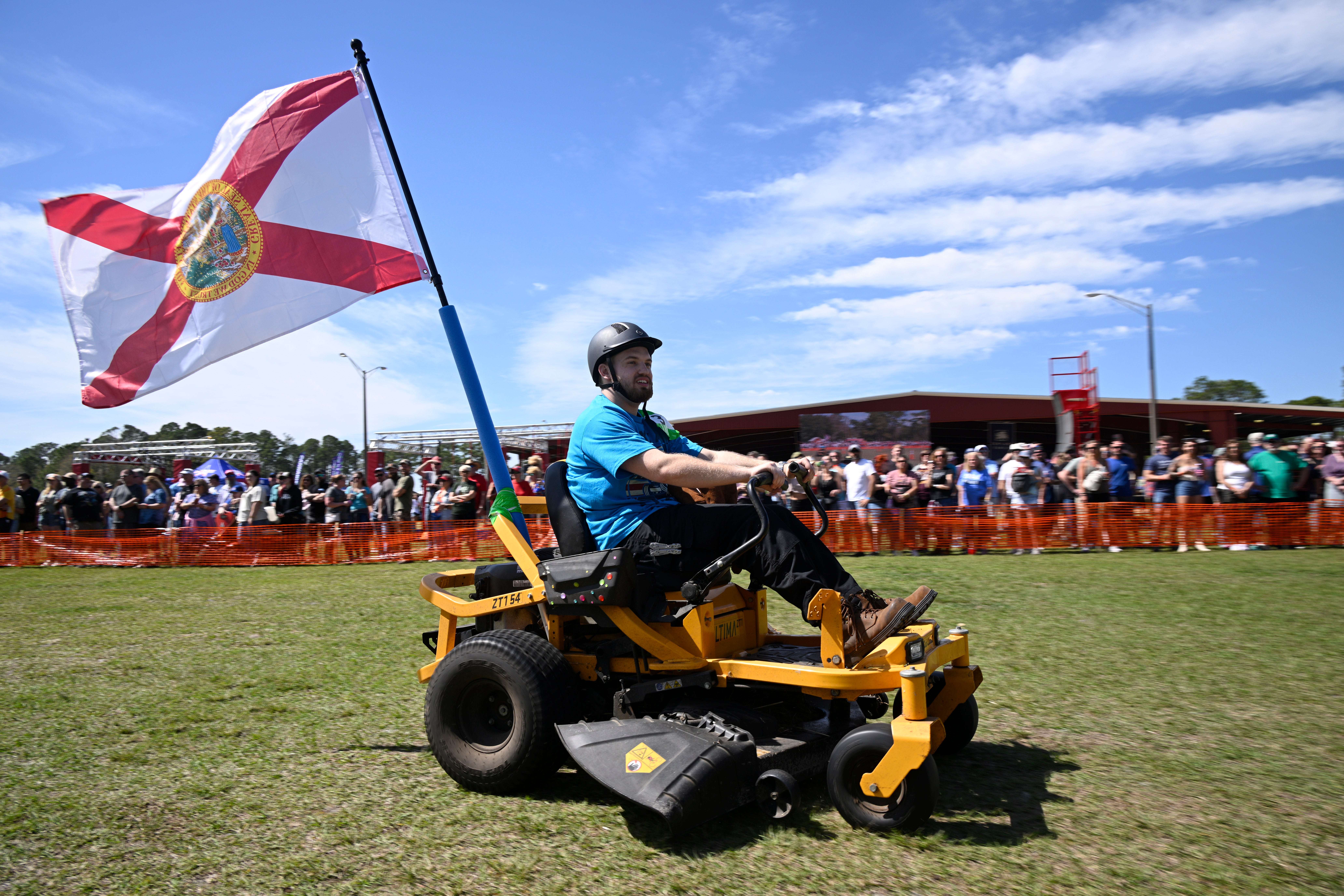 Blake Setser, of Jacksonville, Florida, competes in the lawnmower racing event during the Florida Man Games on Saturday