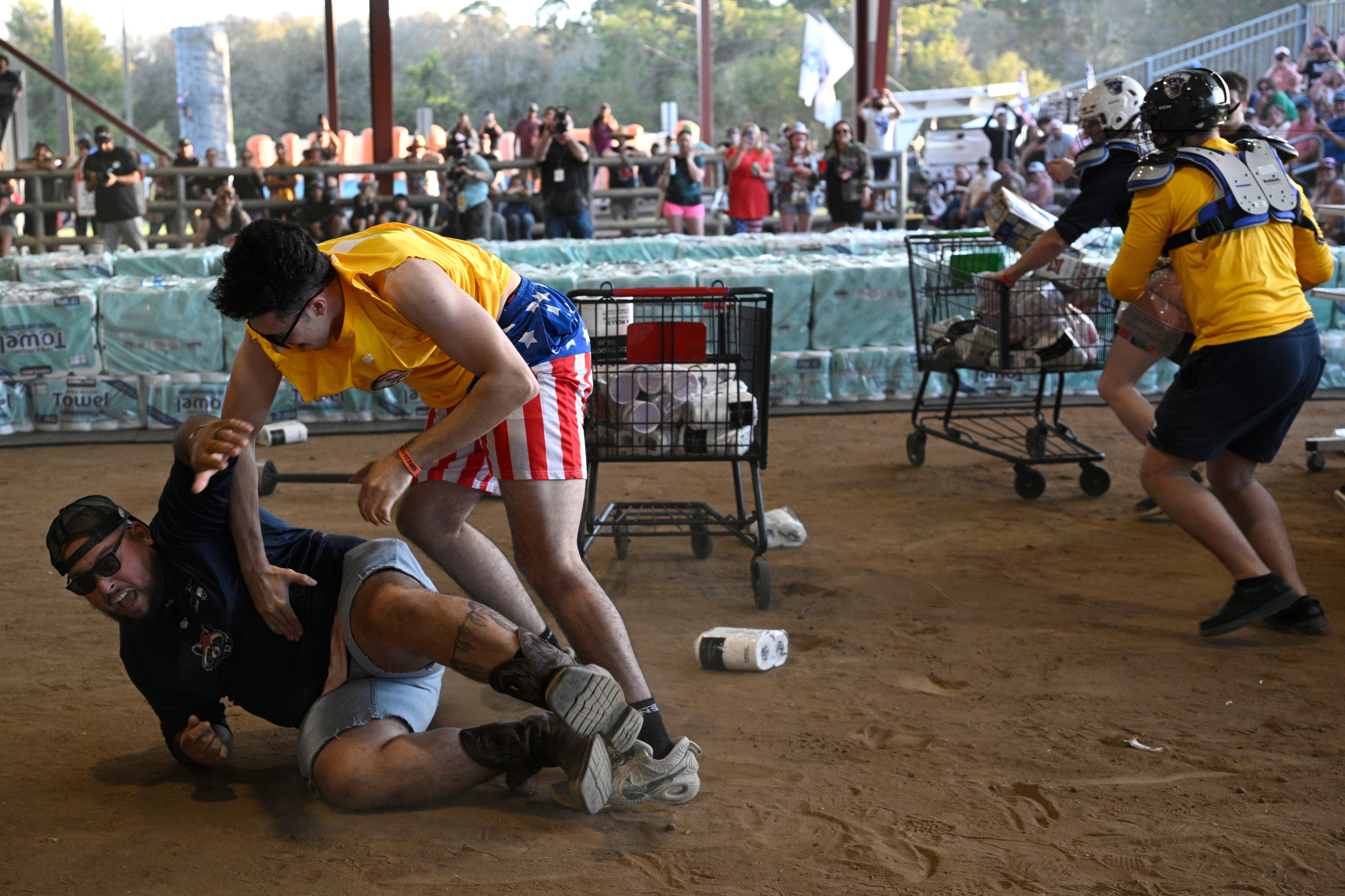 Yusuf Elshihibi, left, and Anthony Meda, second from left, compete in the Hurricane Party Prep: Grocery Aisle Brawl during the Florida Man Games,