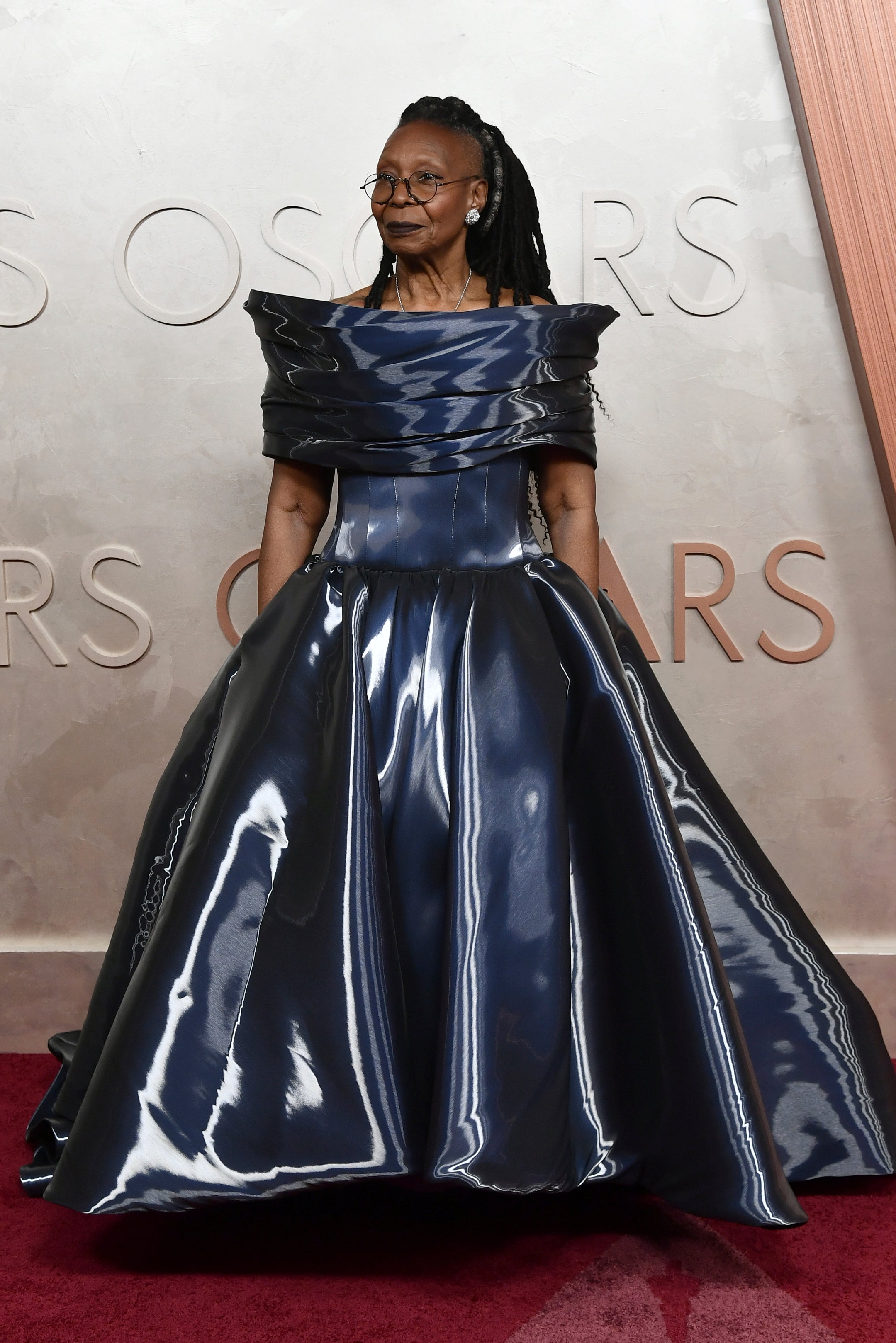 One critic on X said Whoopi Goldberg looked ‘like she crushed a Tesla’ to make her shimmering blue dress