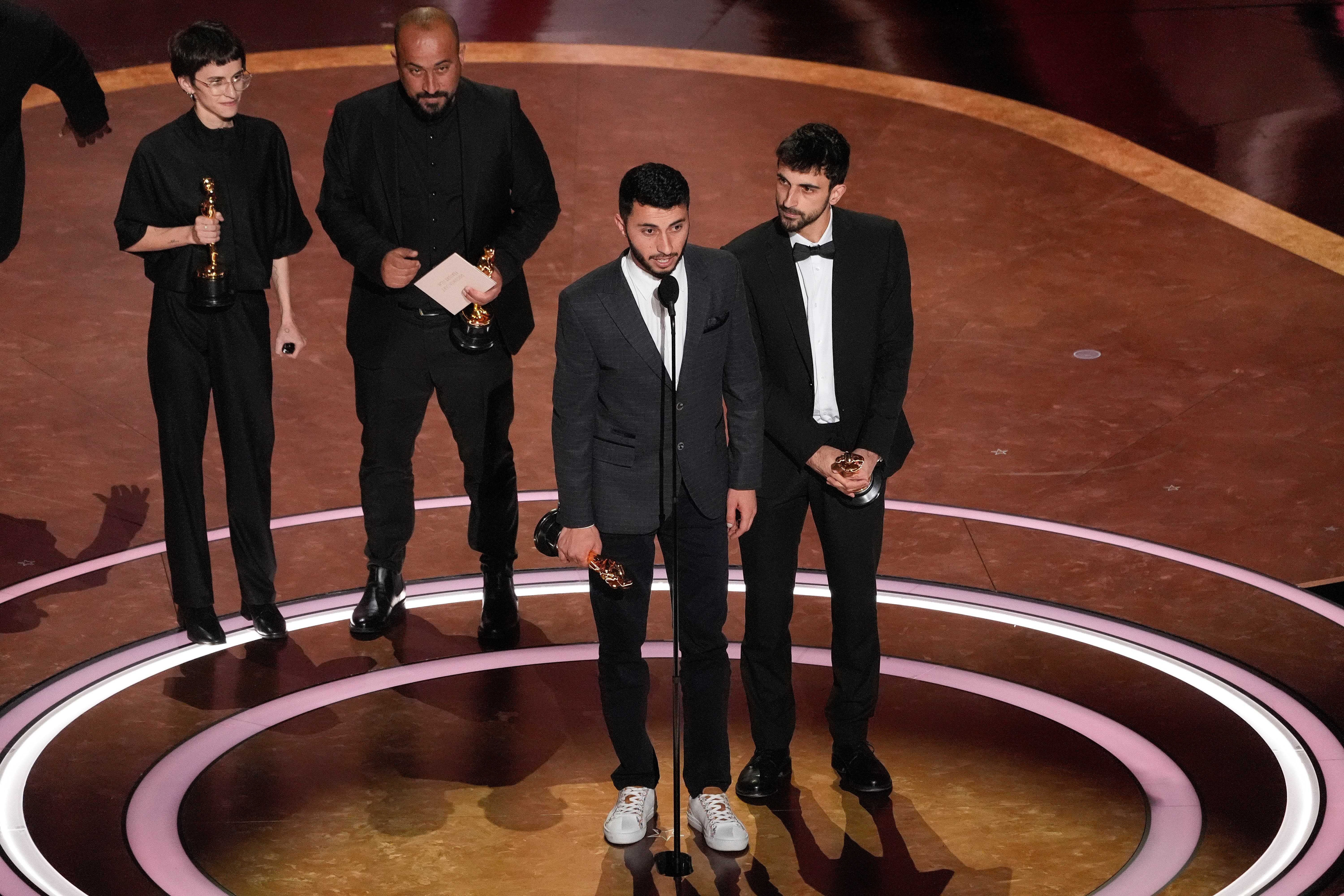 Rachel Szor, Hamdan Ballal, Basel Adra, and Yuval Abraham accept the award for best documentary feature film (Chris Pizzello/AP)
