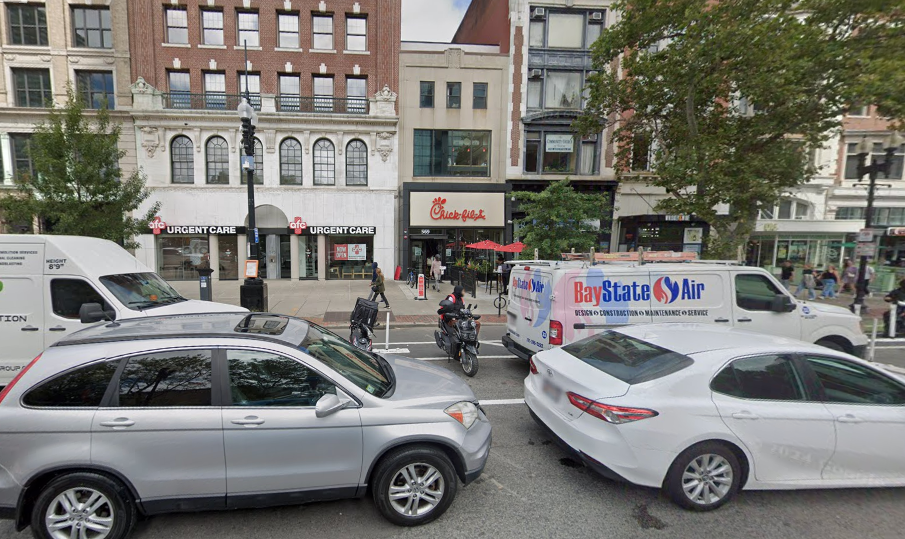 A knife-wielding man was shot along a busy street inside a Chick-fil-A restaurant in Boston Saturday evening