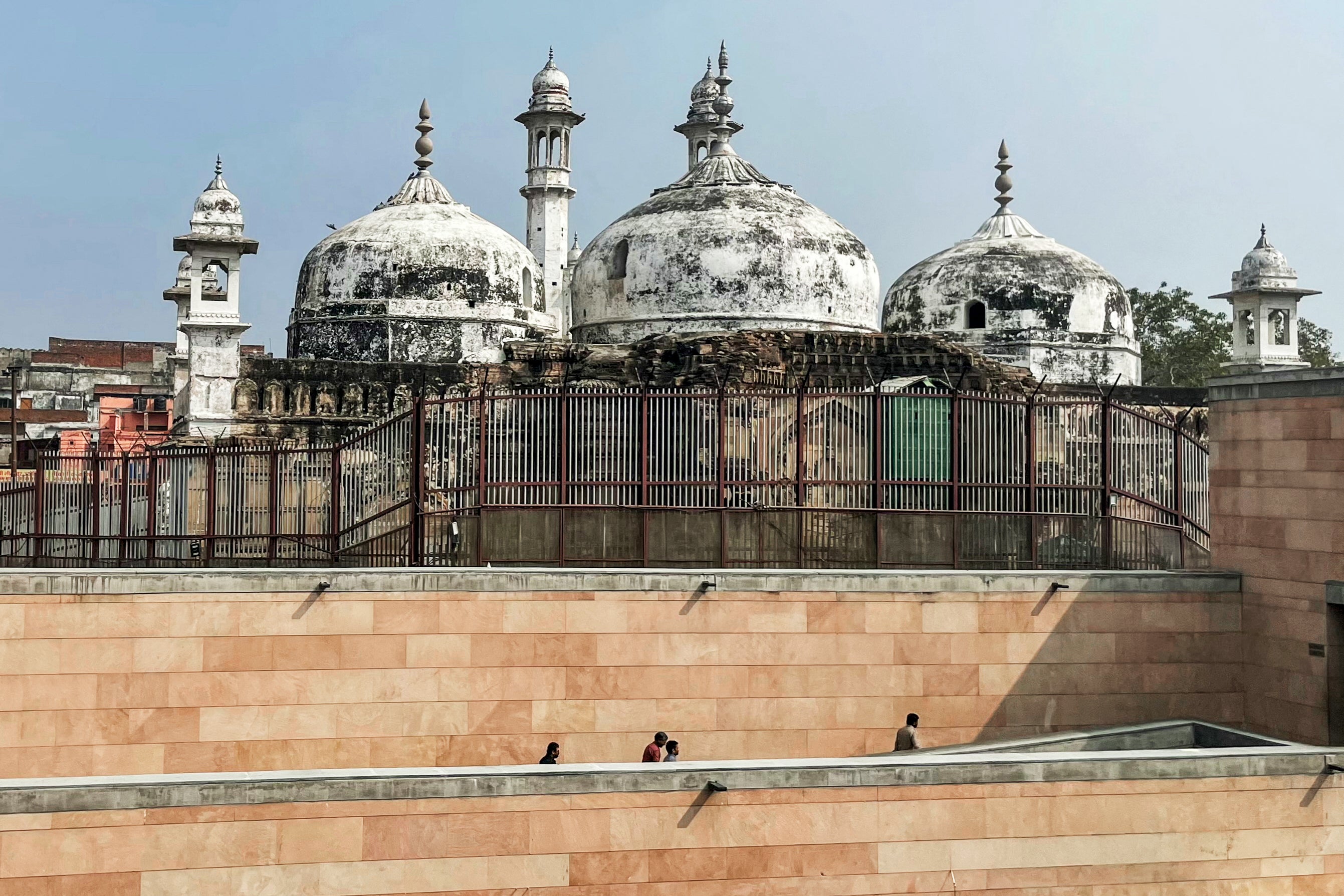 People walk past the Gyanvapi mosque in Varanasi