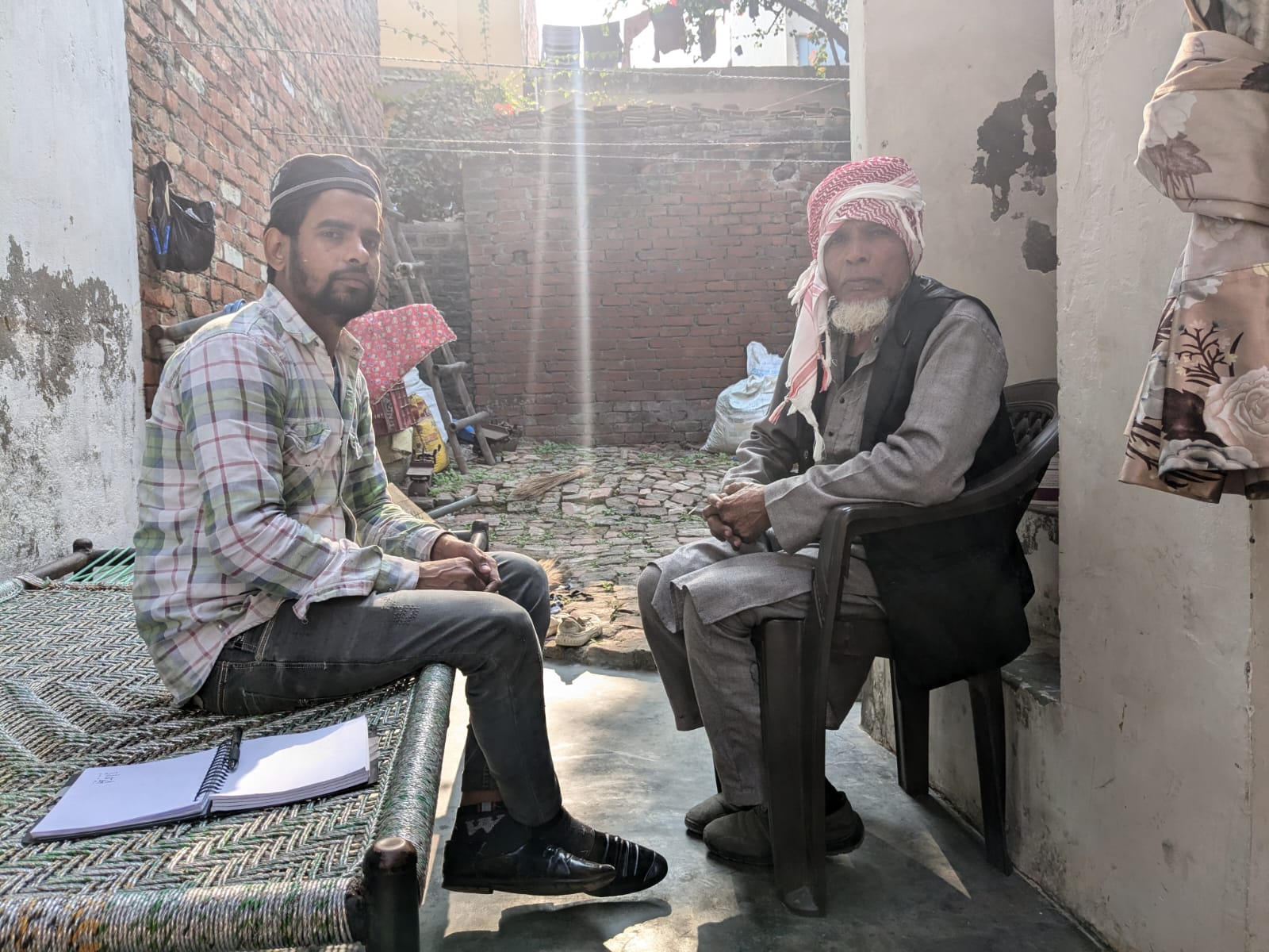 Mohammad Salman, brother of Bilal, sitting with his father at their home in Sambhal