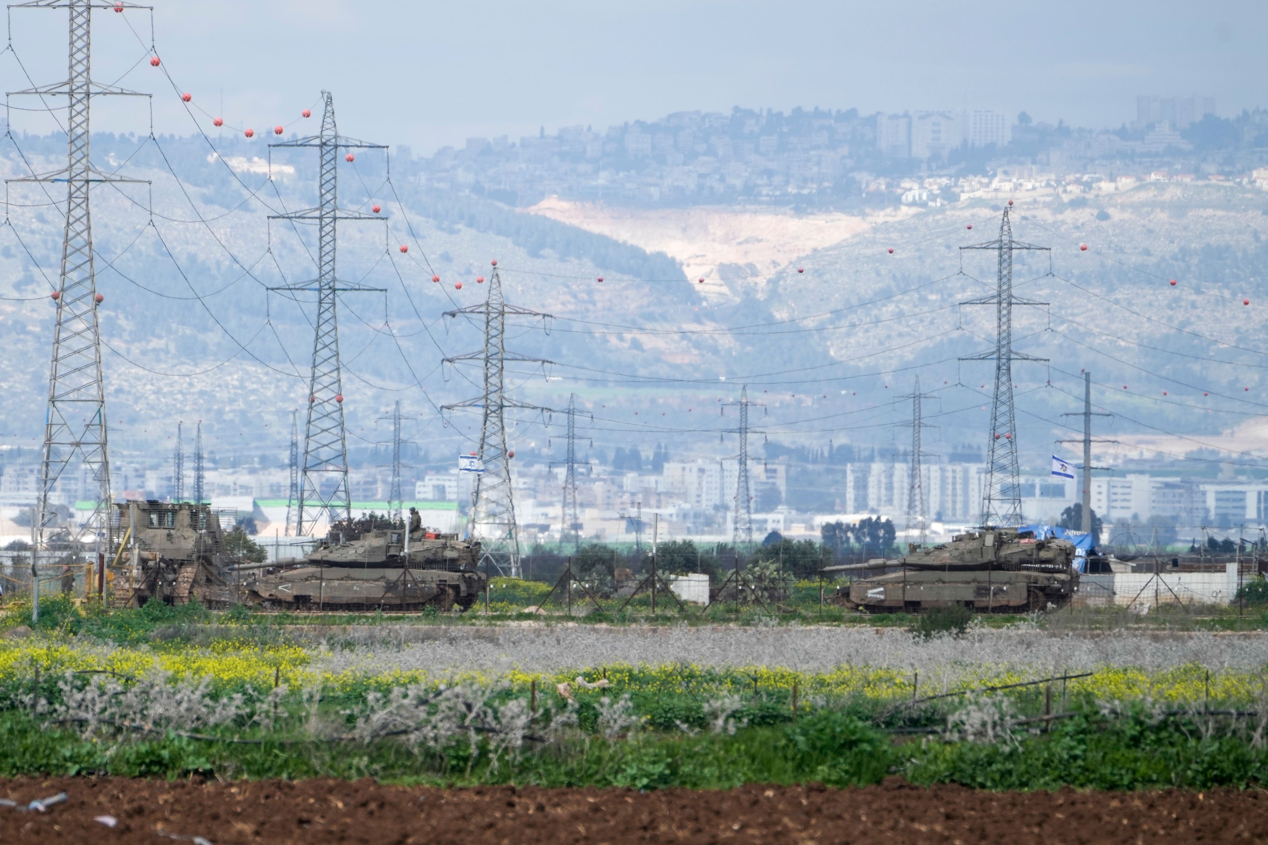 Israeli tanks gather outside of the occupied West Bank near Jenin (Majdi Mohammed/AP)