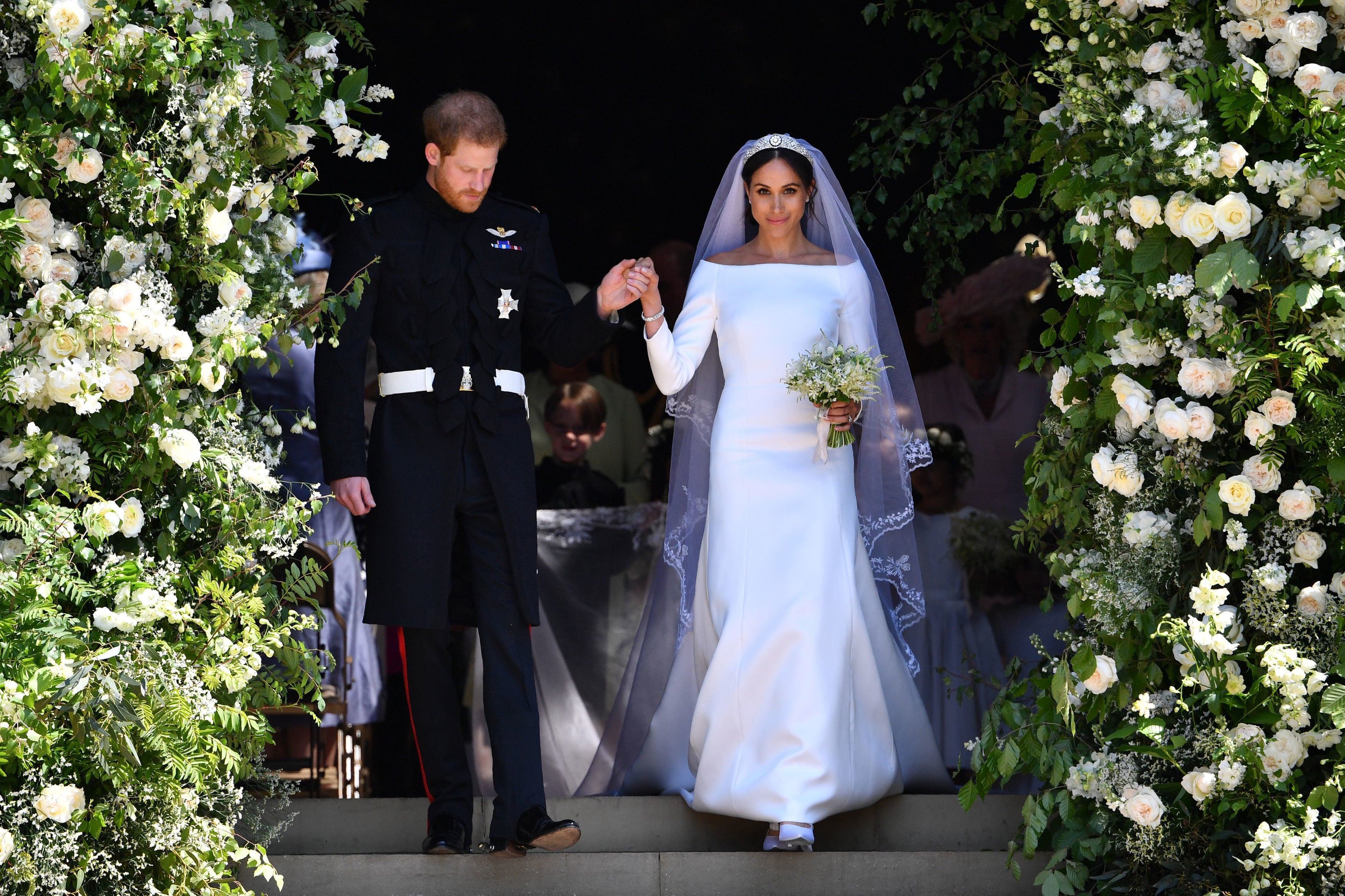 Picture perfect: Harry and Meghan surrounded by an archway of flowers on their wedding day