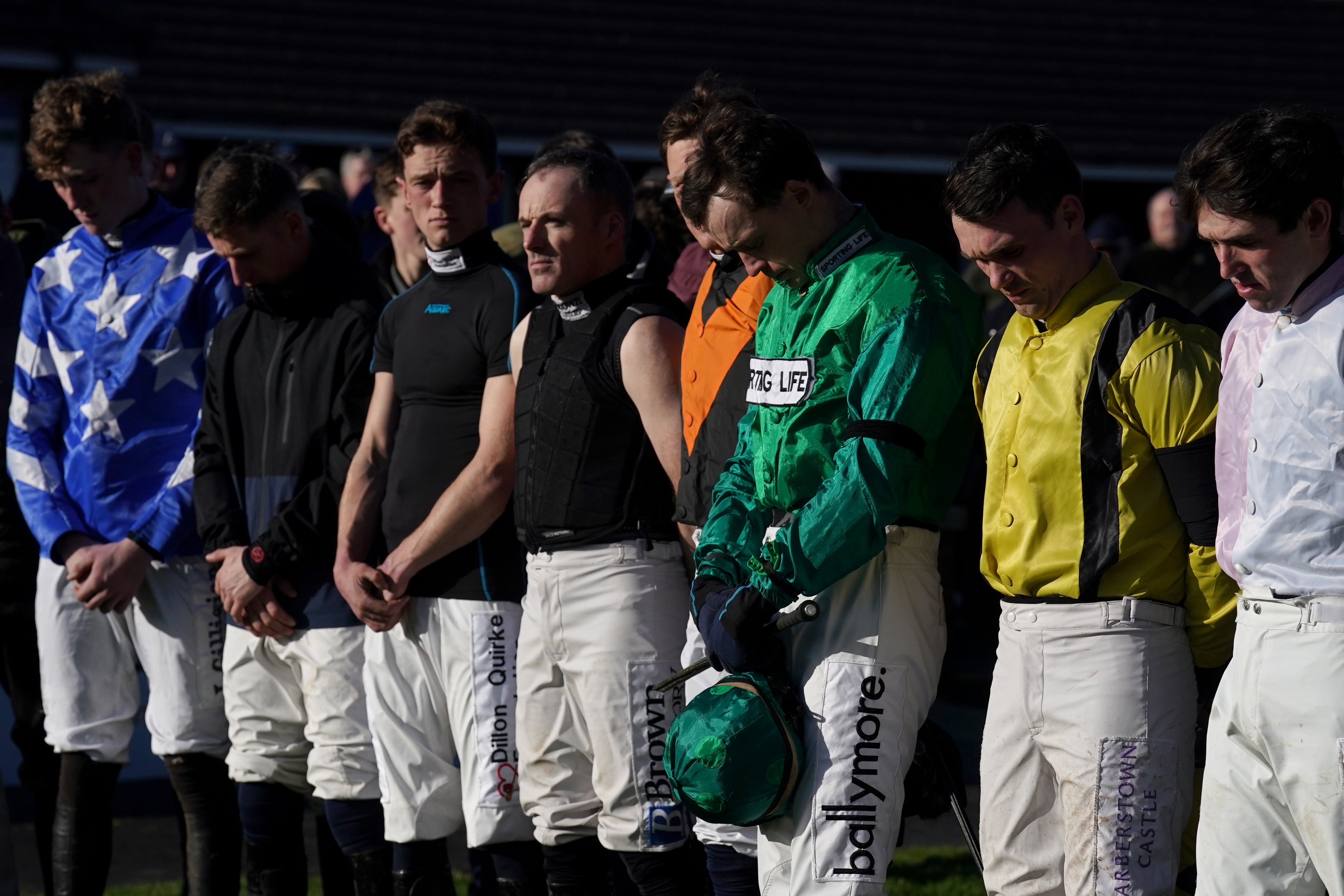 Jockeys stand for a minute's silence in memory of Michael O'Sullivan at Fairyhouse Racecourse