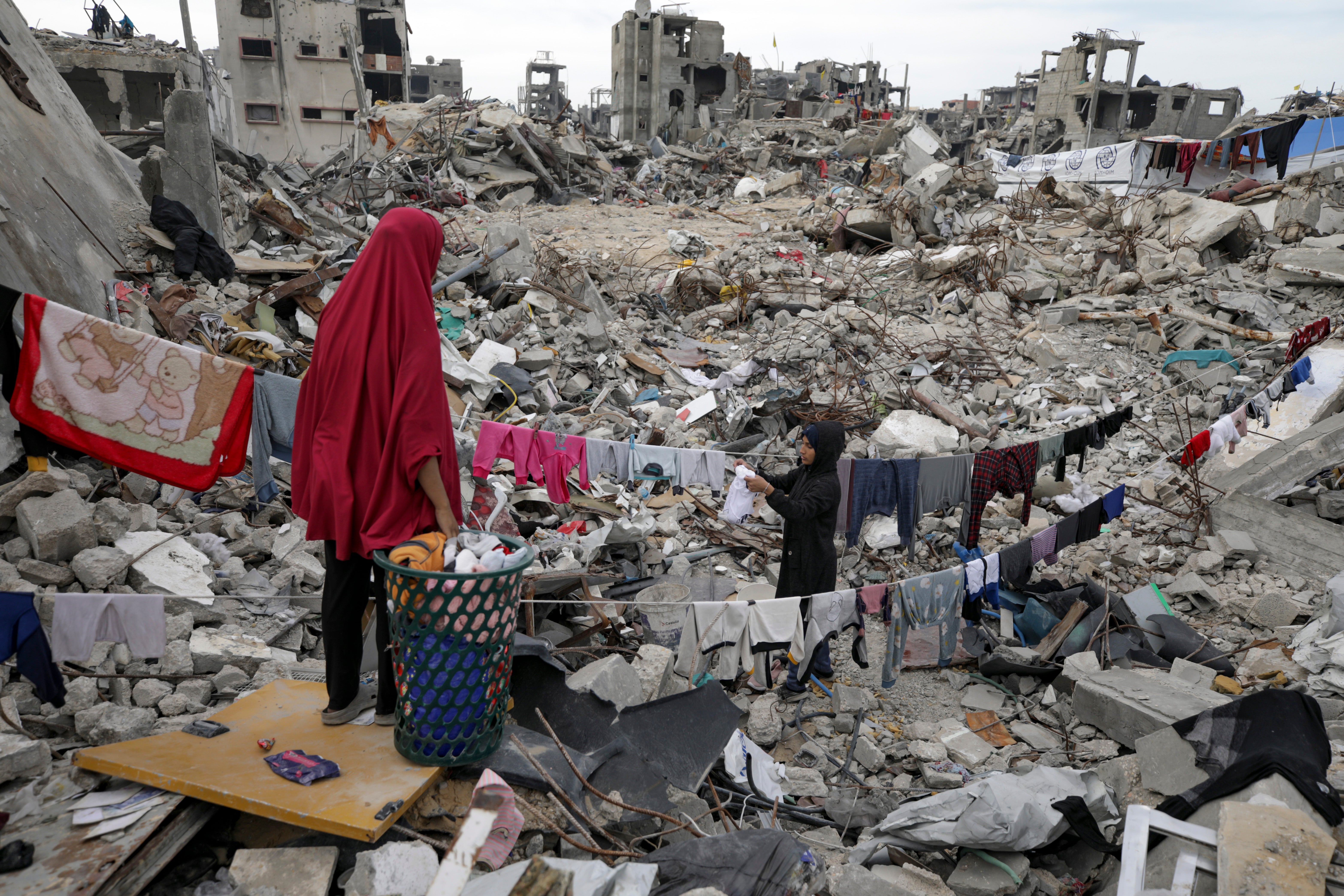 A family returns to the ruins of their home in Jabalia, Gaza