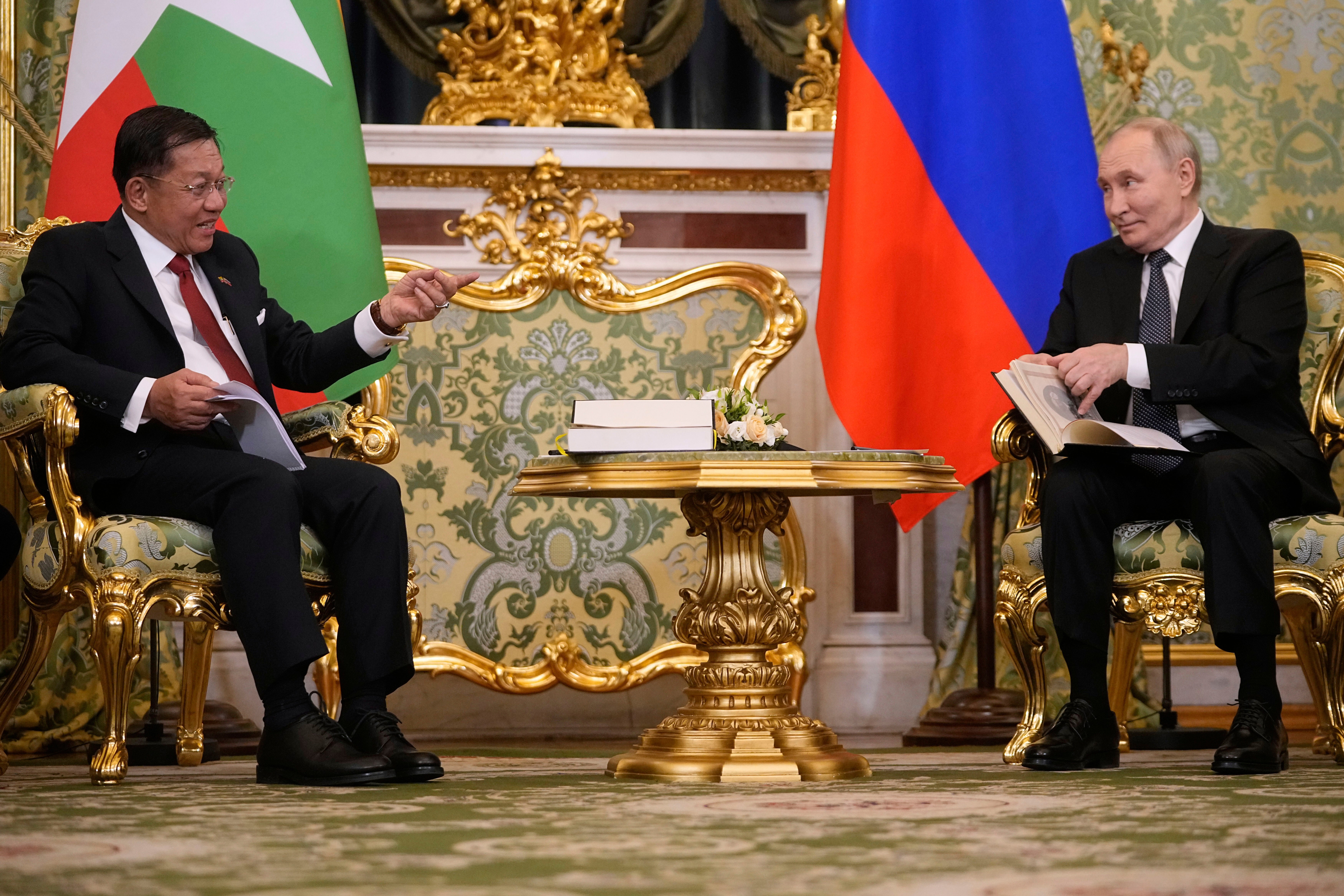 Russian President Vladimir Putin, right, and Myanmar's Military leader Senior Gen. Min Aung Hlaing talk during their meeting at the Grand Kremlin Palace in Moscow, Russia, 4 March