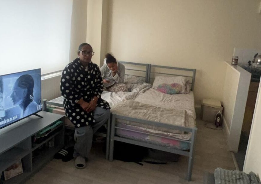 Sonia pictured with her daughter on the beds they sleep on in their council flat