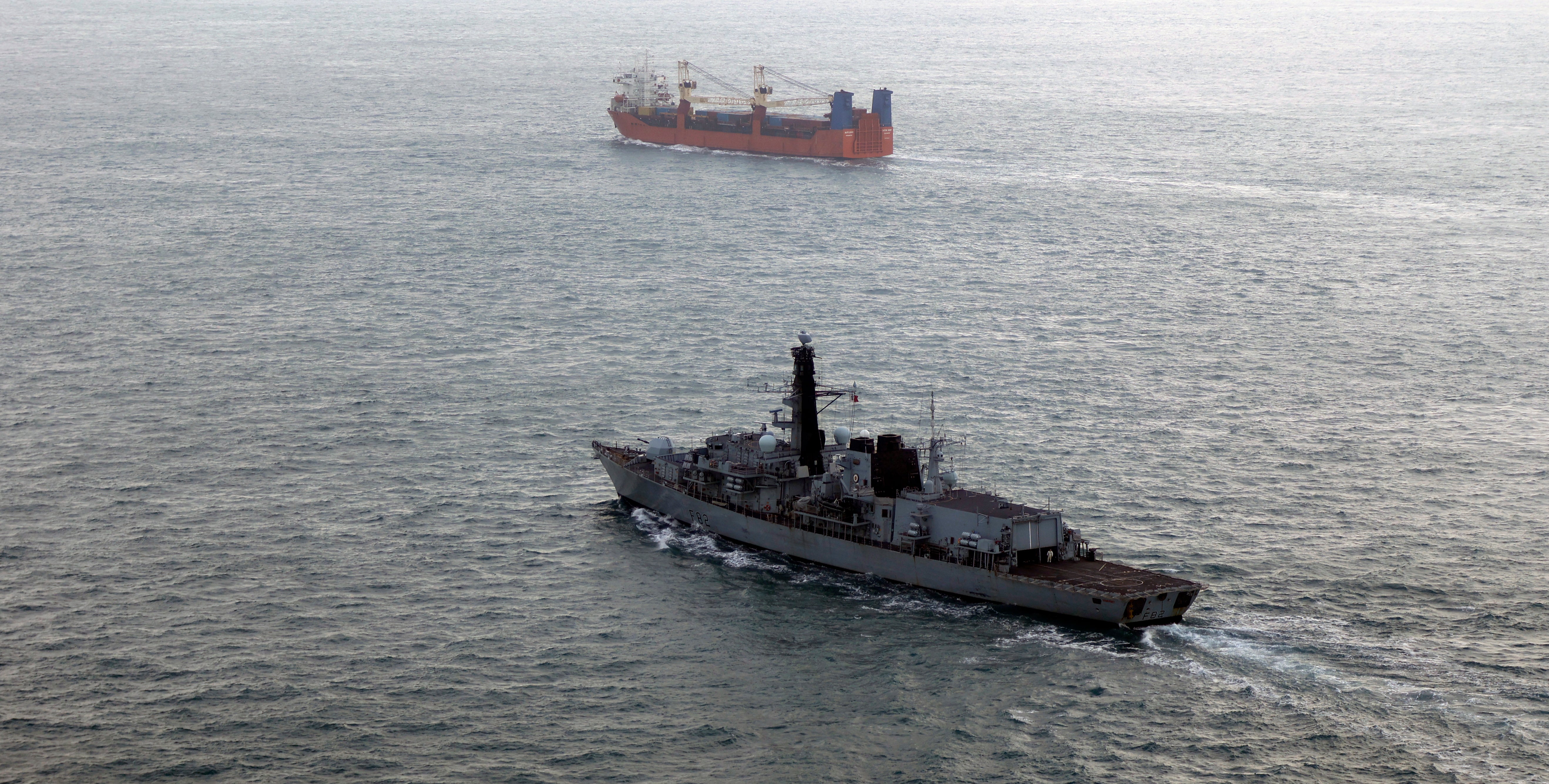 HMS Somerset (left) follows Russian corvette Boikiy during a 3-day operation monitoring the progress of a Russian task group