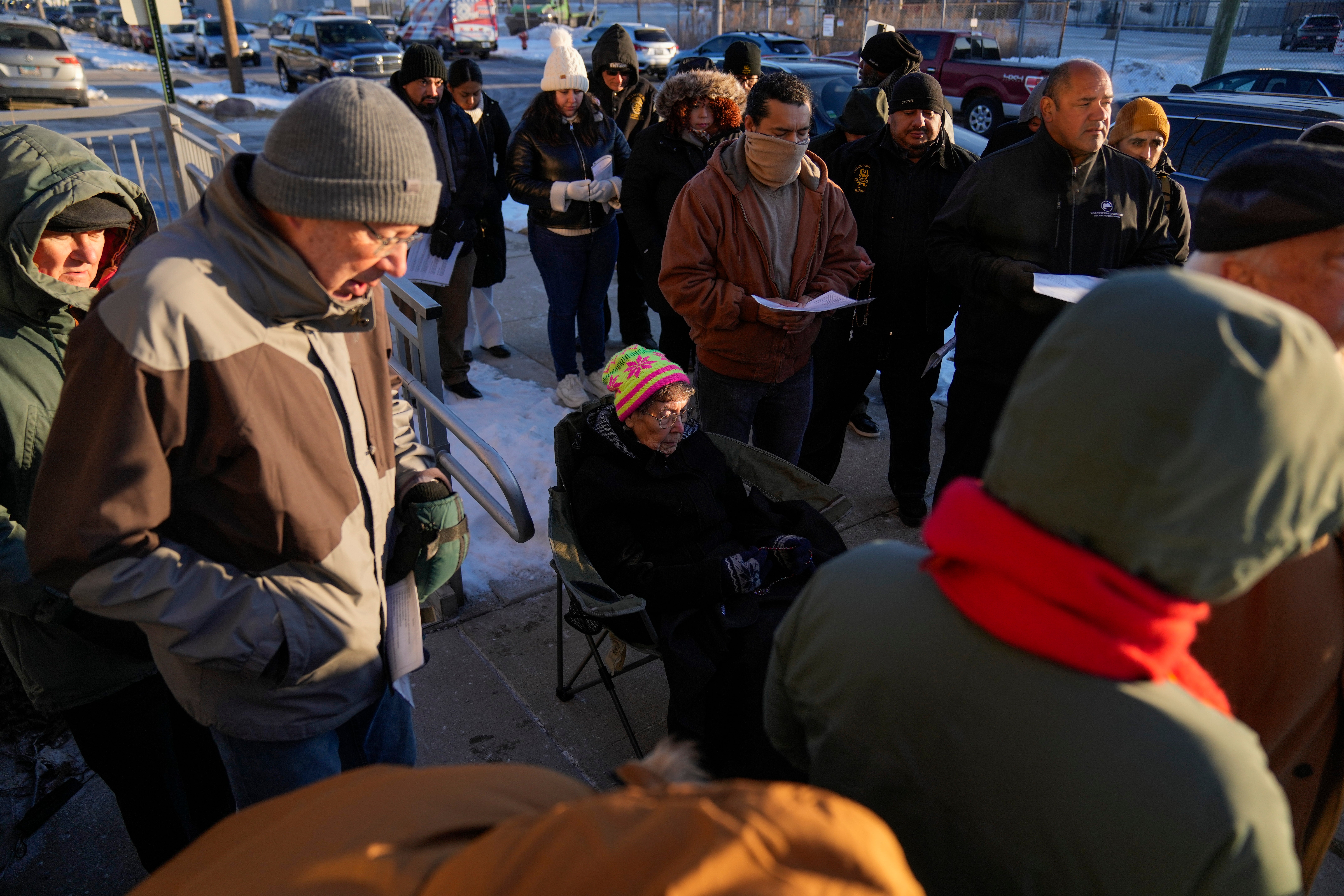 Sister JoAnn Persch, center, a nun with the Sisters of Mercy, prays with others during a vigil outside a United States Customs and Immigration Enforcement detention facility