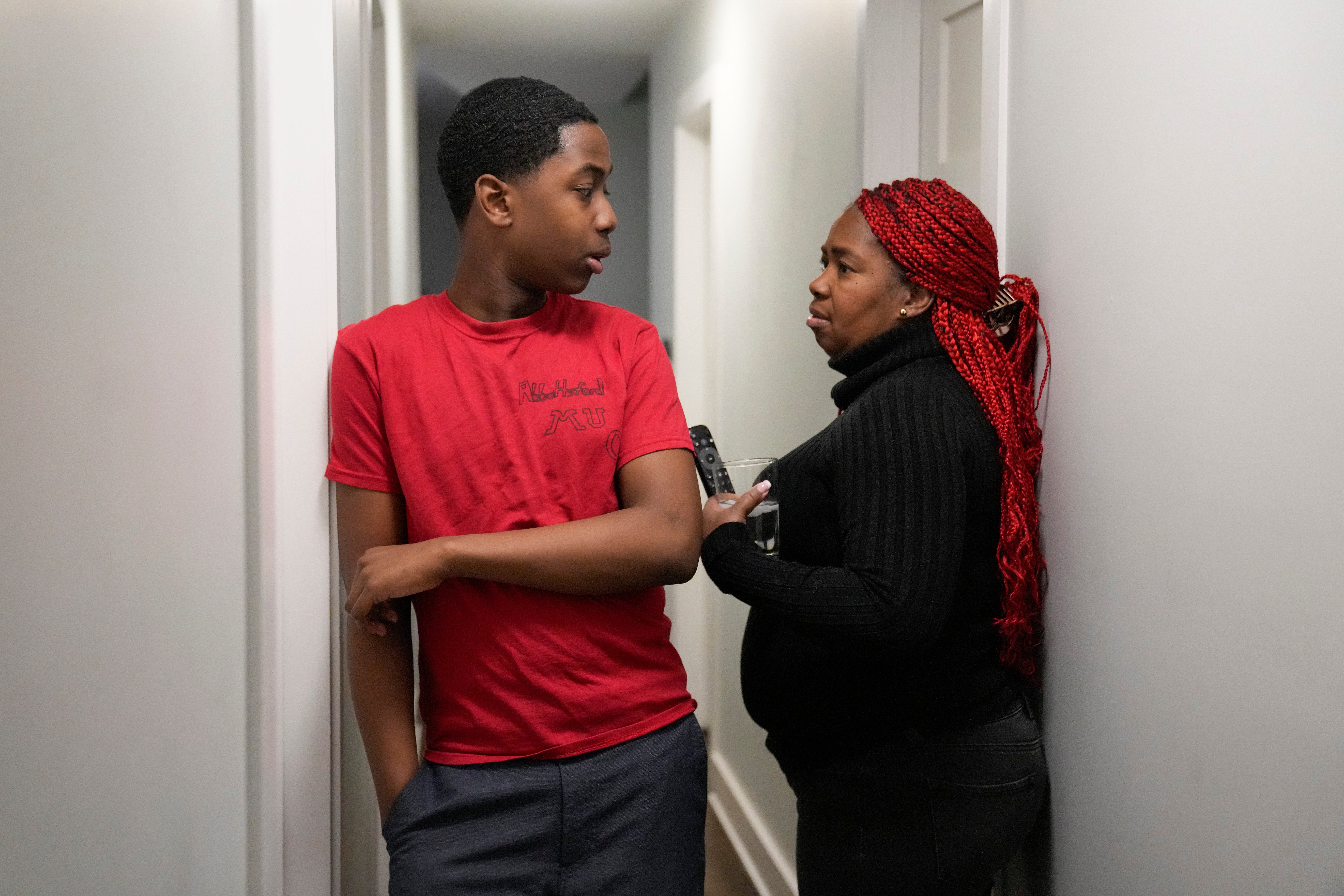 Zuleika, right, and her son Josafat, 14, immigrants from Central America seeking asylum, speak together at their home