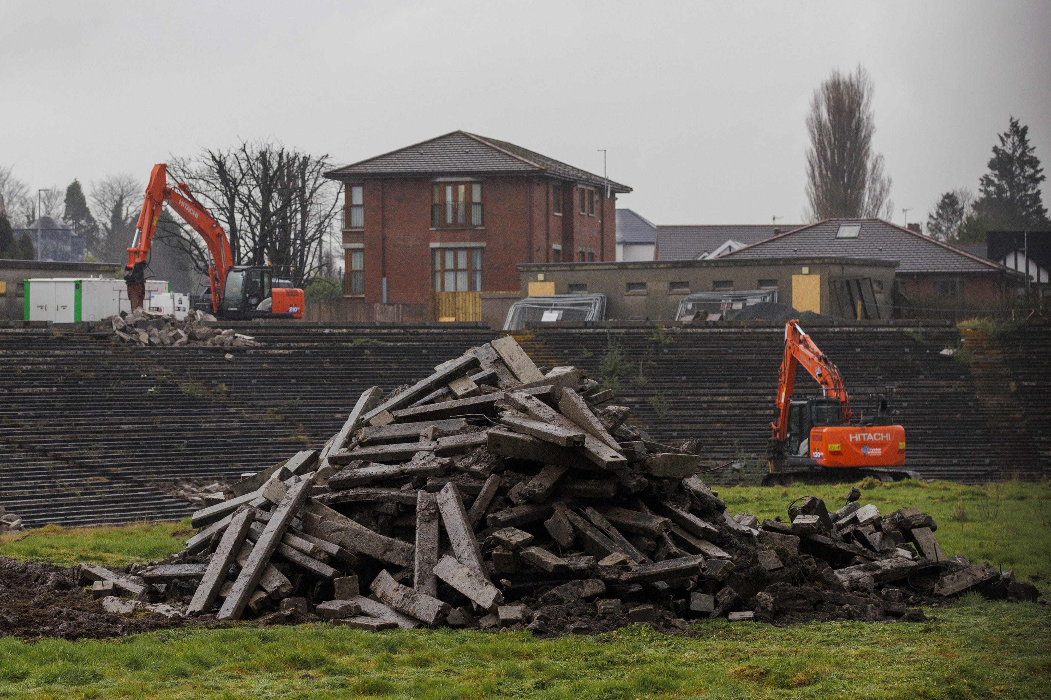 Contractors with excavators have begun clearing the concrete seating terraces at GAA stadium in Belfast (PA)