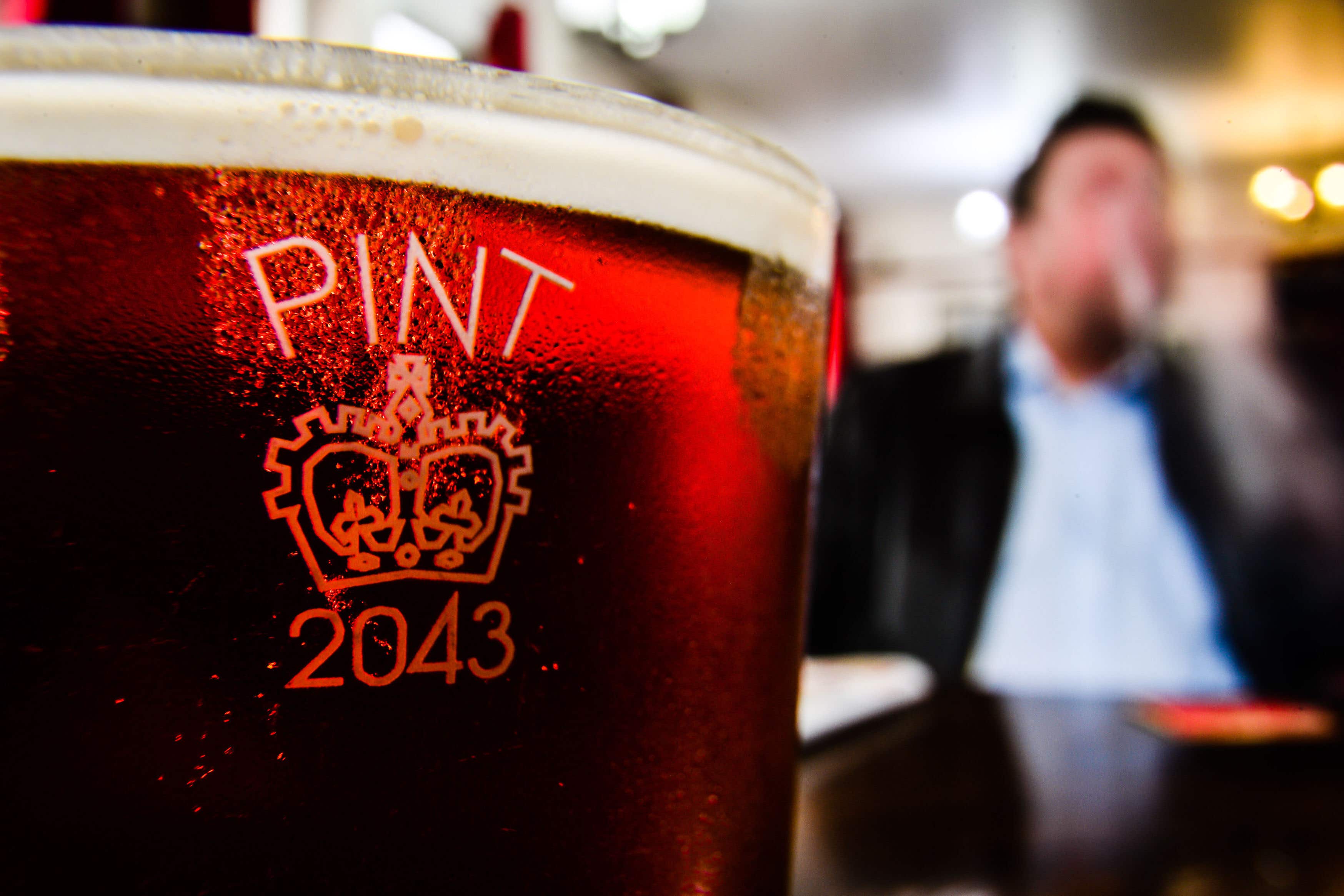 A pint glass etched with the Crown stamp (Ben Birchall/PA)