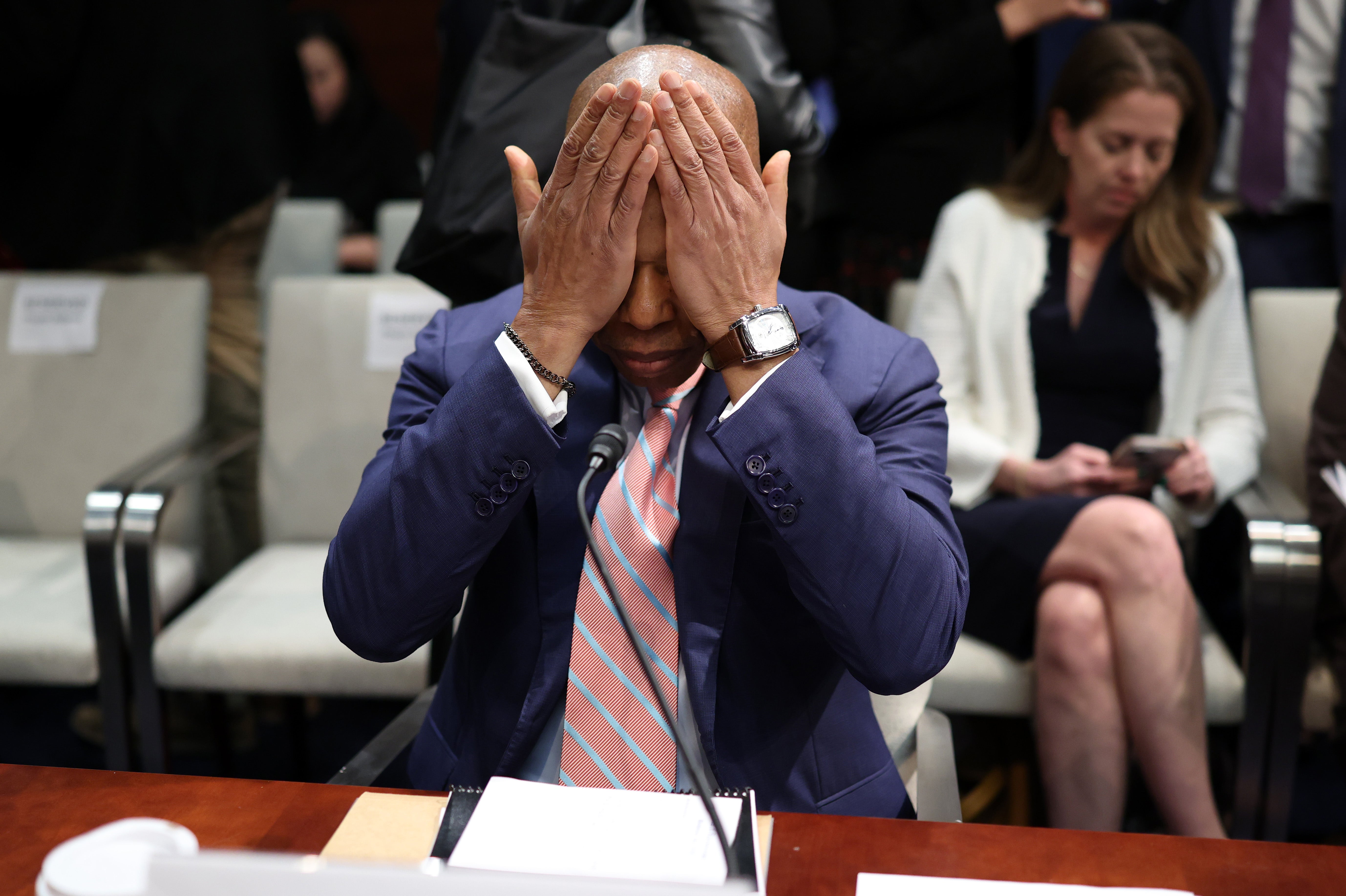 New York City Mayor Eric Adams reacts during a break in a House Oversight Committee. Moments of the hearing were wild as representatives launched attacks at the mayors