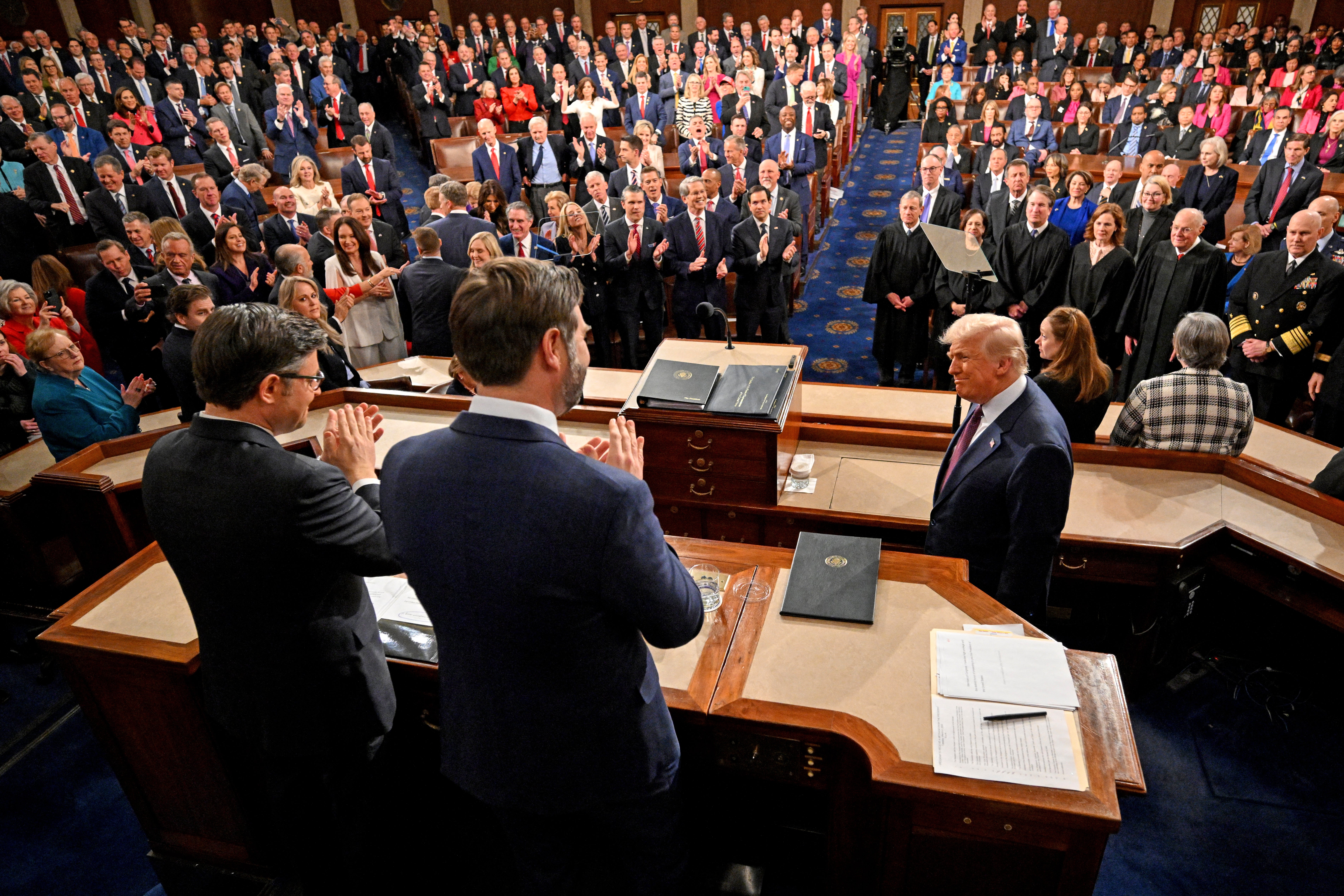 Trump is applauded by US Vice President JD Vance and Speaker of the House Mike Johnson