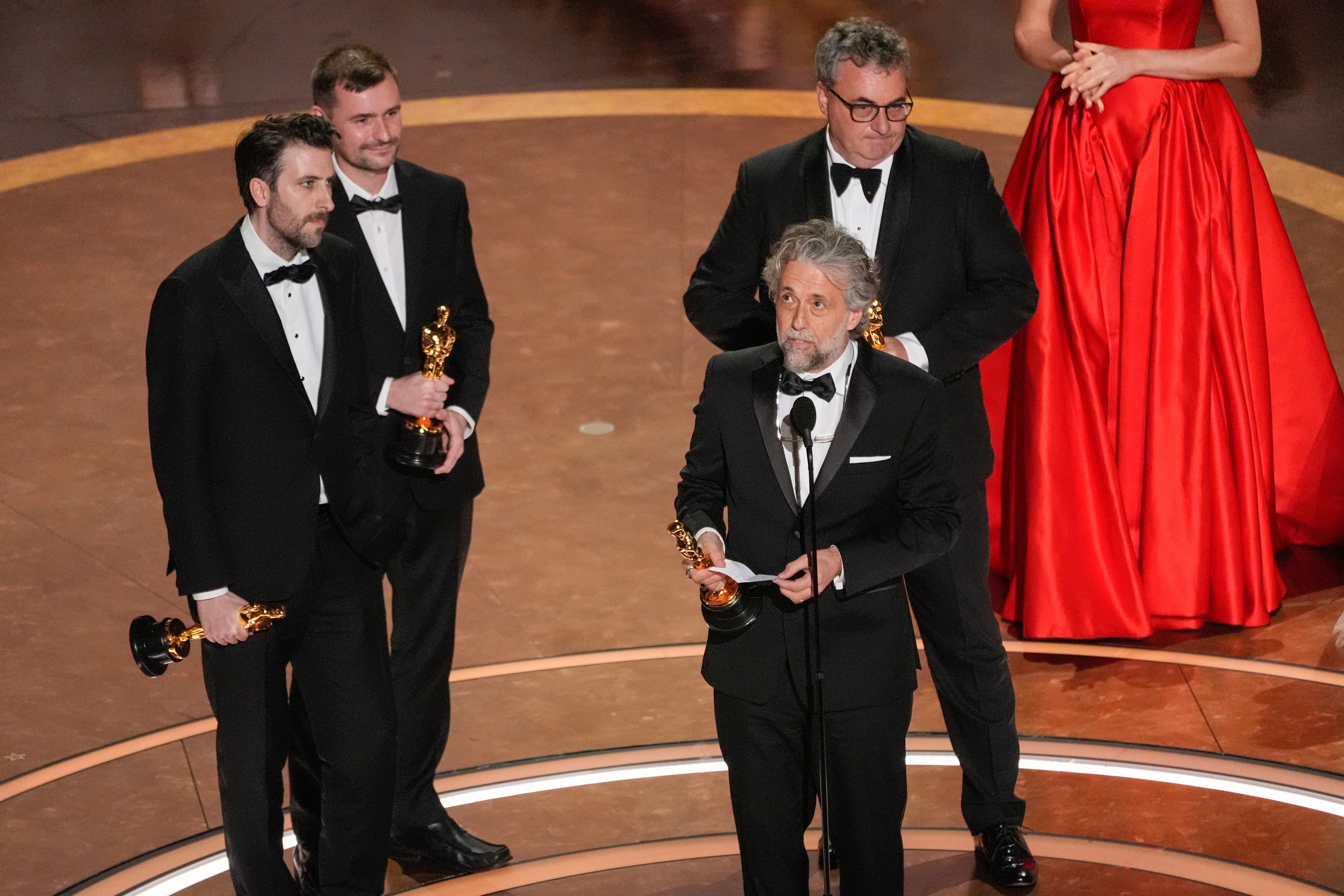 Stephen James, from left, Rhys Salcombe, Paul Lambert, and Gerd Nefzer accept the award for best visual effects for "Dune: Part Two" during the Oscars