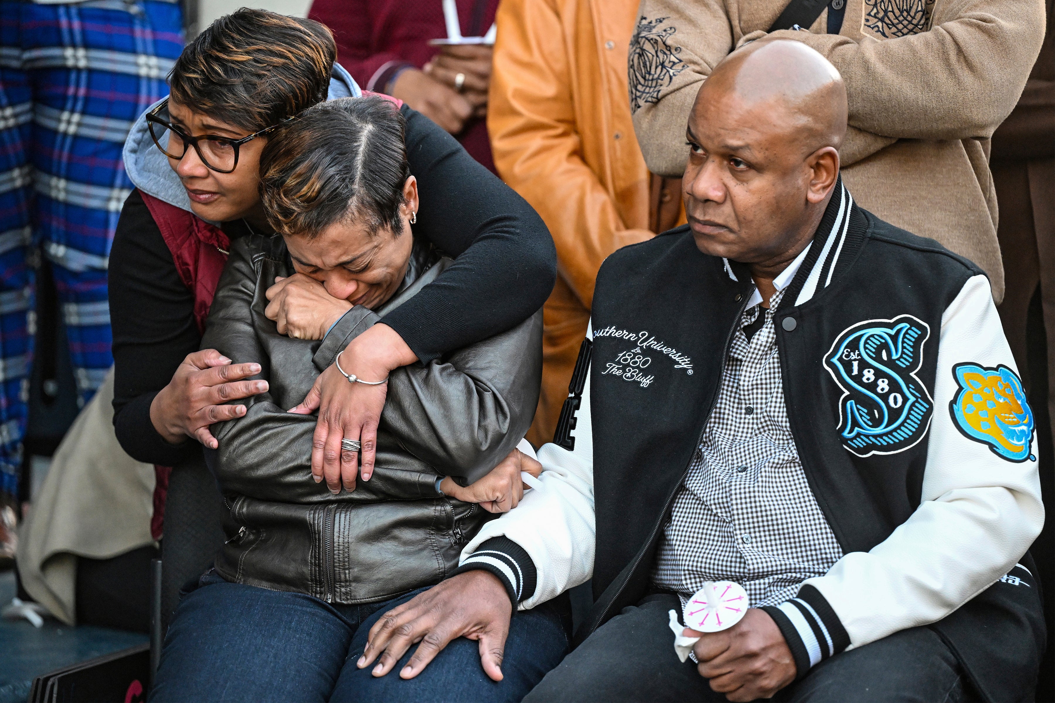 Caleb’s father Corey Wilson mourns alongside other grieving family members