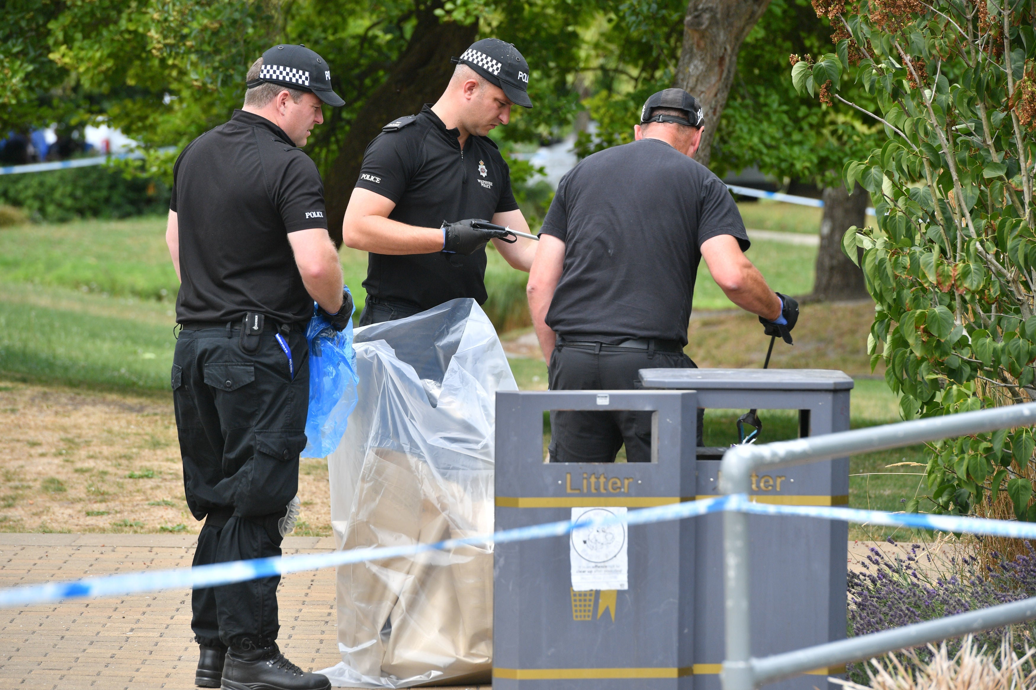 Police bag items as they conduct searches of Queen Elizabeth Gardens, Salisbury, where Dawn Sturgess visited before she fell ill after coming into contact with novichok