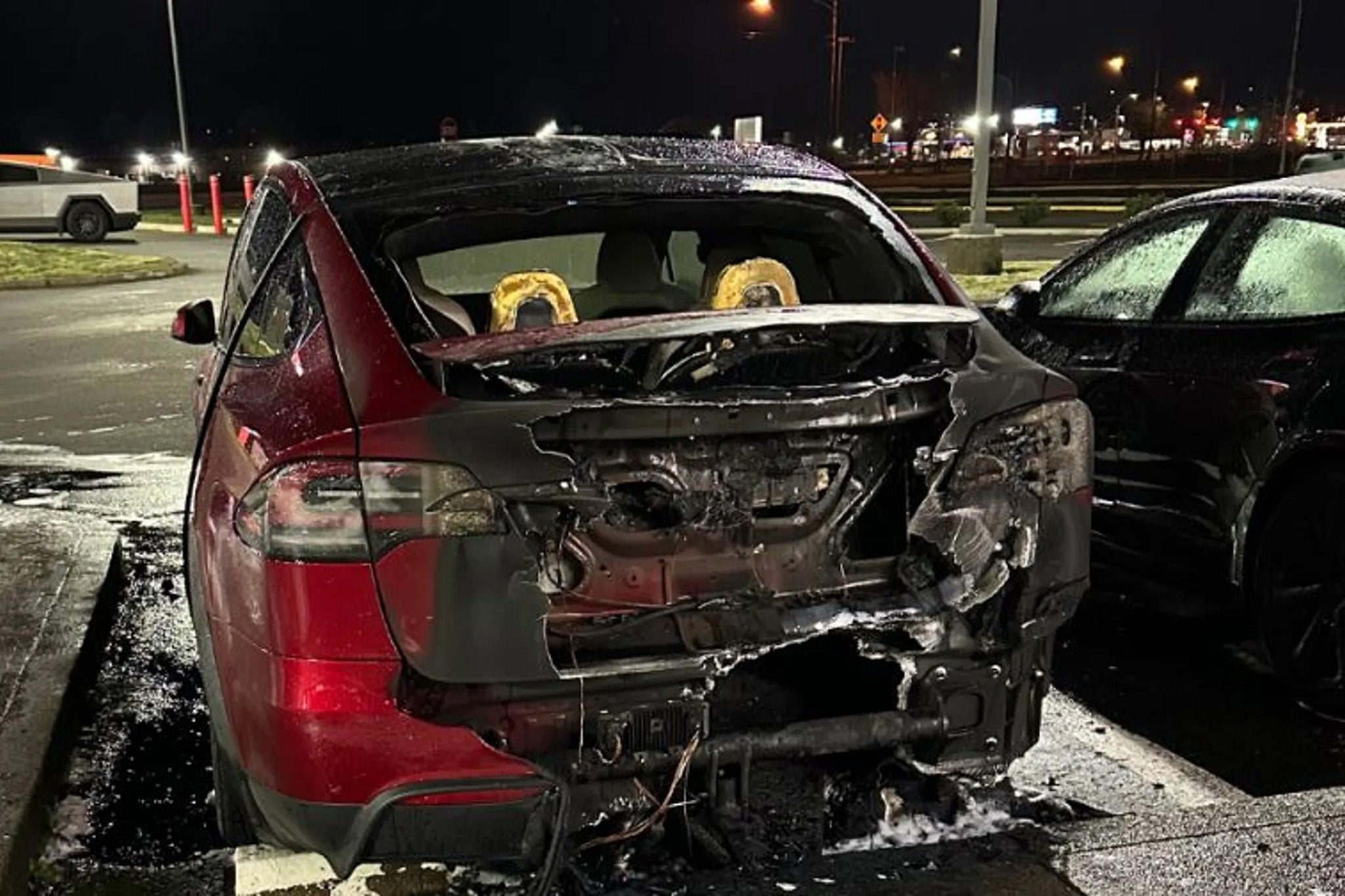 The aftermath of the attack on a red Tesla outside of the dealership