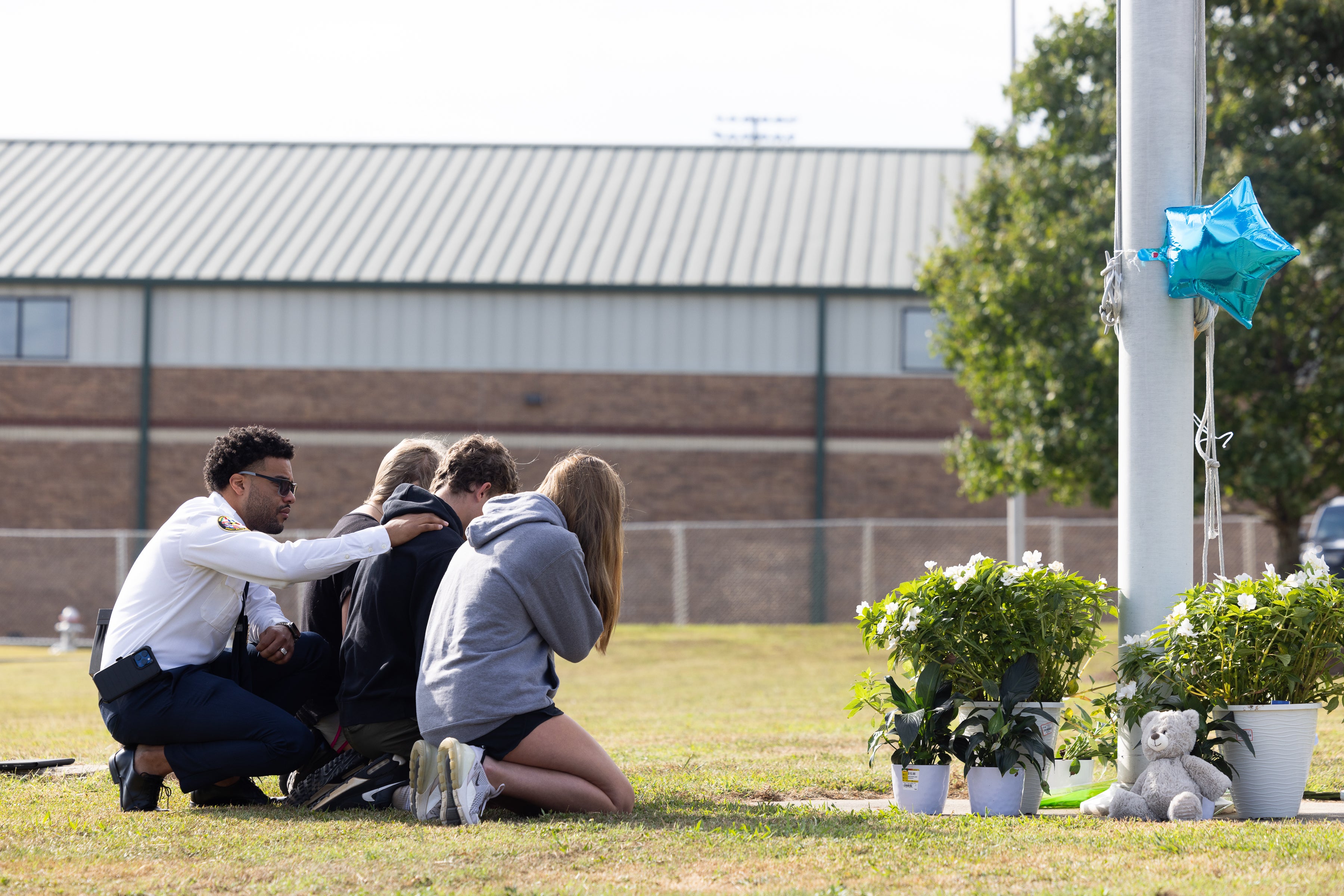 Researchers at the University of Colorado at Boulder have found that 7 percent of adults in the U.S. have been at the scene of a mass shooting. And, more than 2 percent been injured during one. Pictured: Mourners outside a Georgia high school that was the scene of a mass shooting