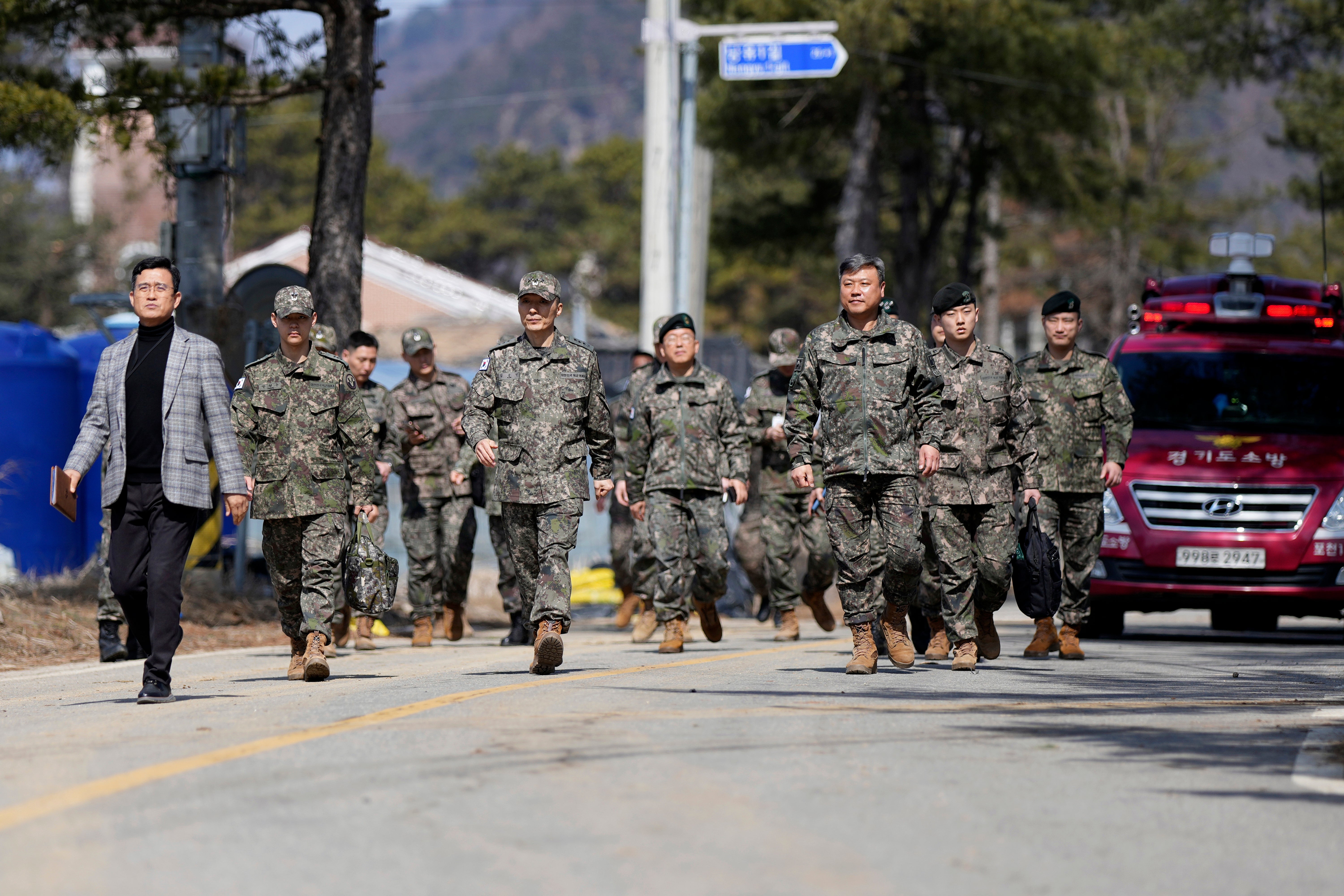 Military personnel walk near where the bombs were accidentally dropped
