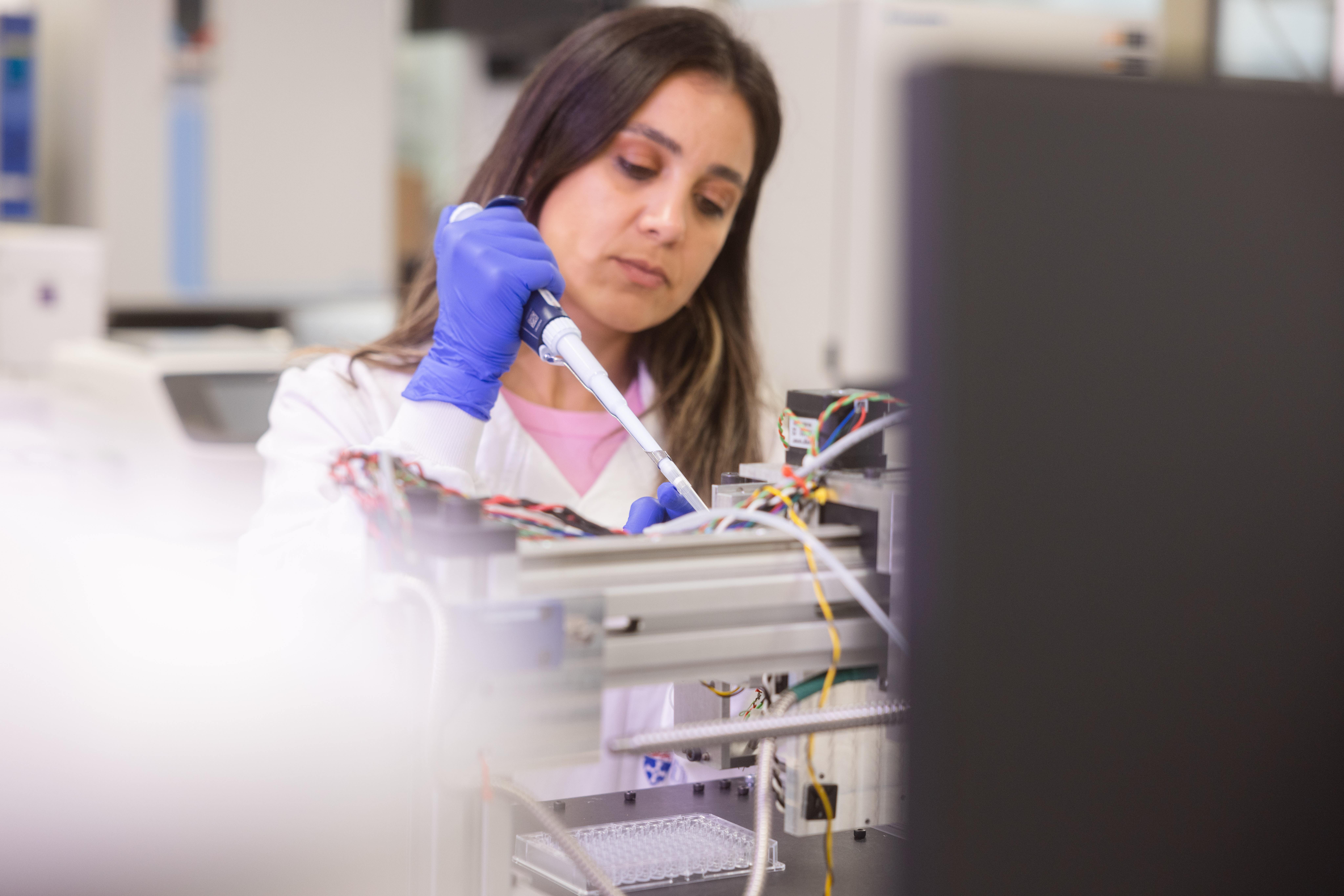 A member of the research team working with the new 3D bioprinter in the lab at Newcastle University (PA)
