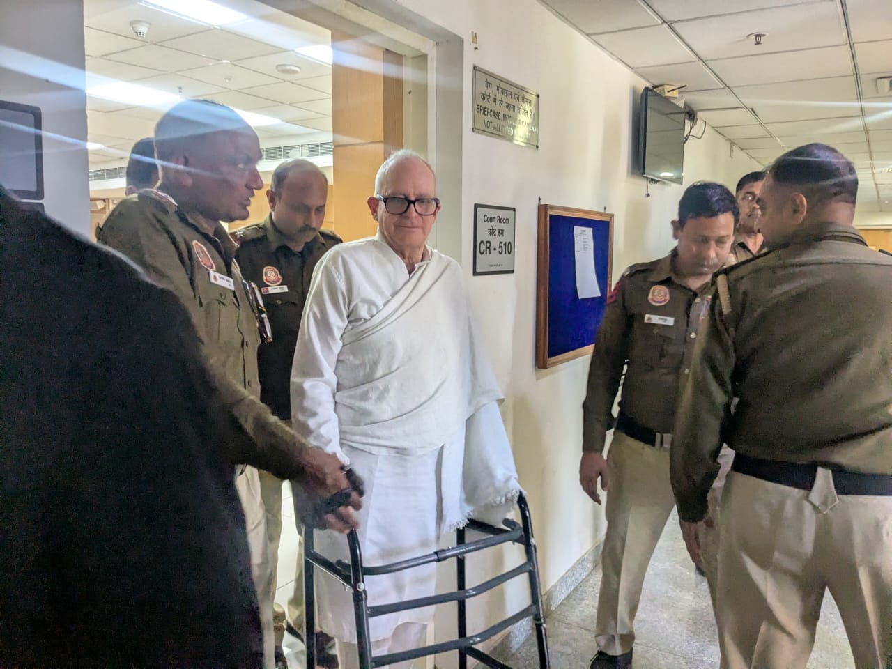 Delhi police officials guide Christian Michel out of the courtroom on 7 March 2025