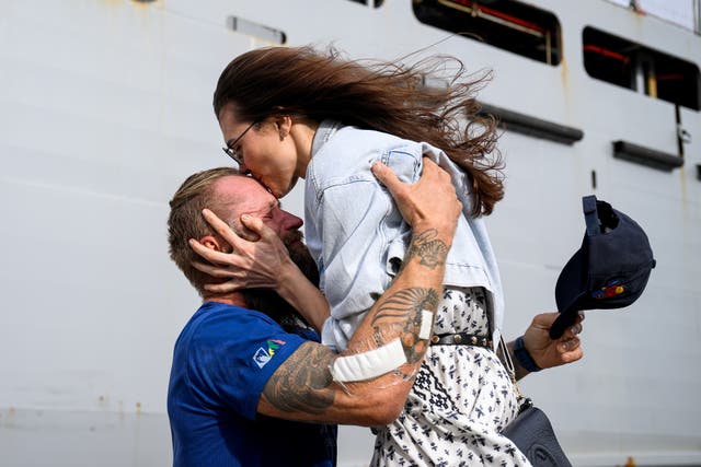 <p>Lithuanian rower Aurimas Mockus (L) and his wife Sonata Mockuviene embrace after reuniting at HMAS Kuttabul naval base in Sydney, Australia, 07 March 2025. The Australian Navy rescued Aurimas Mockus after being caught in Tropical Cyclone Alfred off the Queensland coast</p>