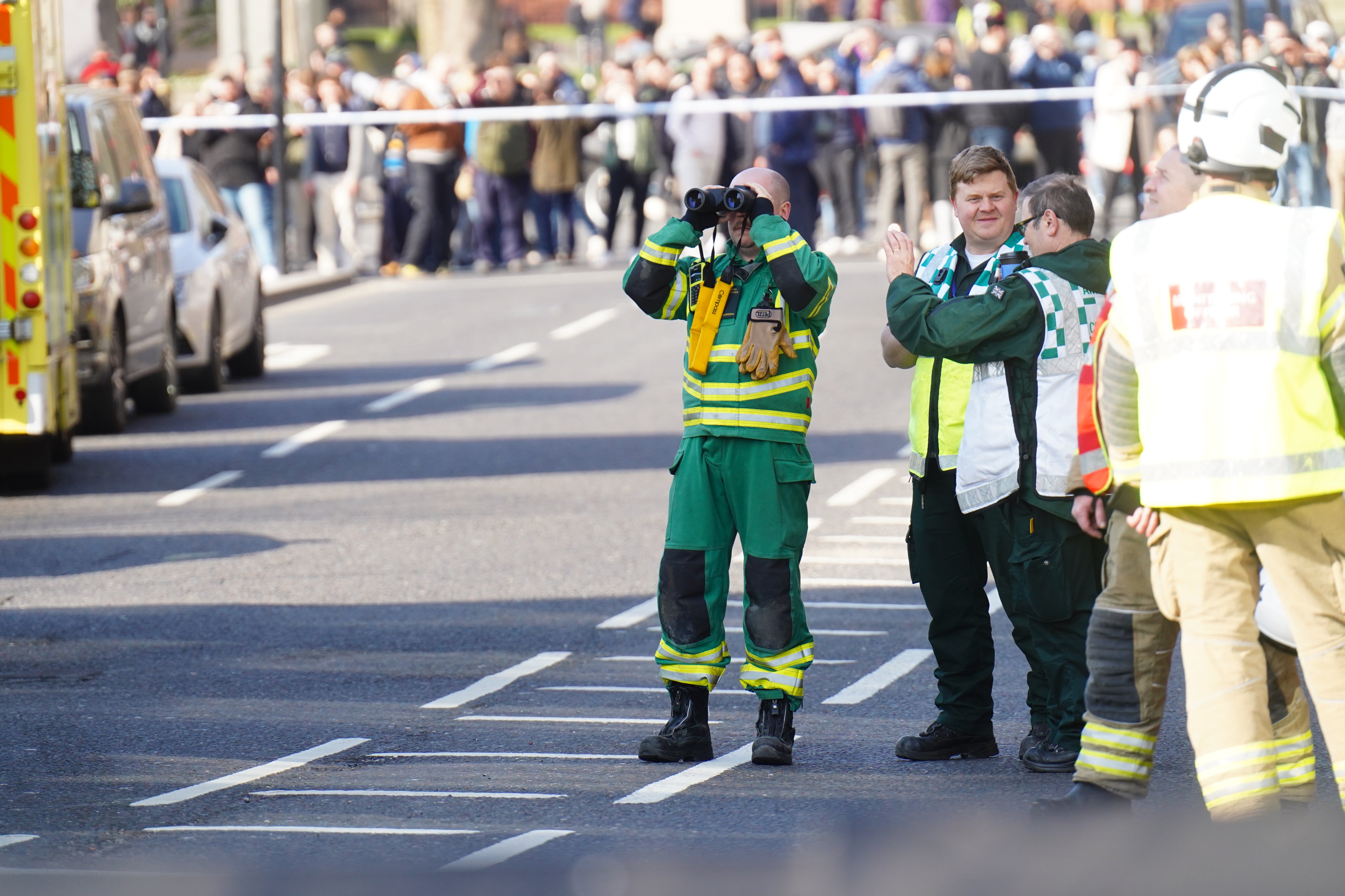 Members of the emergency services discuss the situation, which went on throughout Saturday